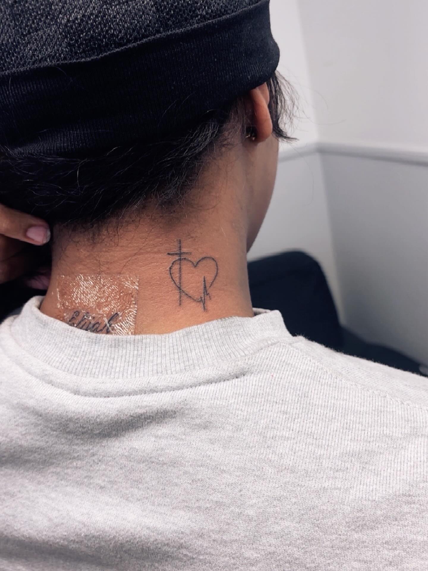 Heart with cross black and grey tattoo on the neck by Syneca Wilson, Acton, Massachusetts