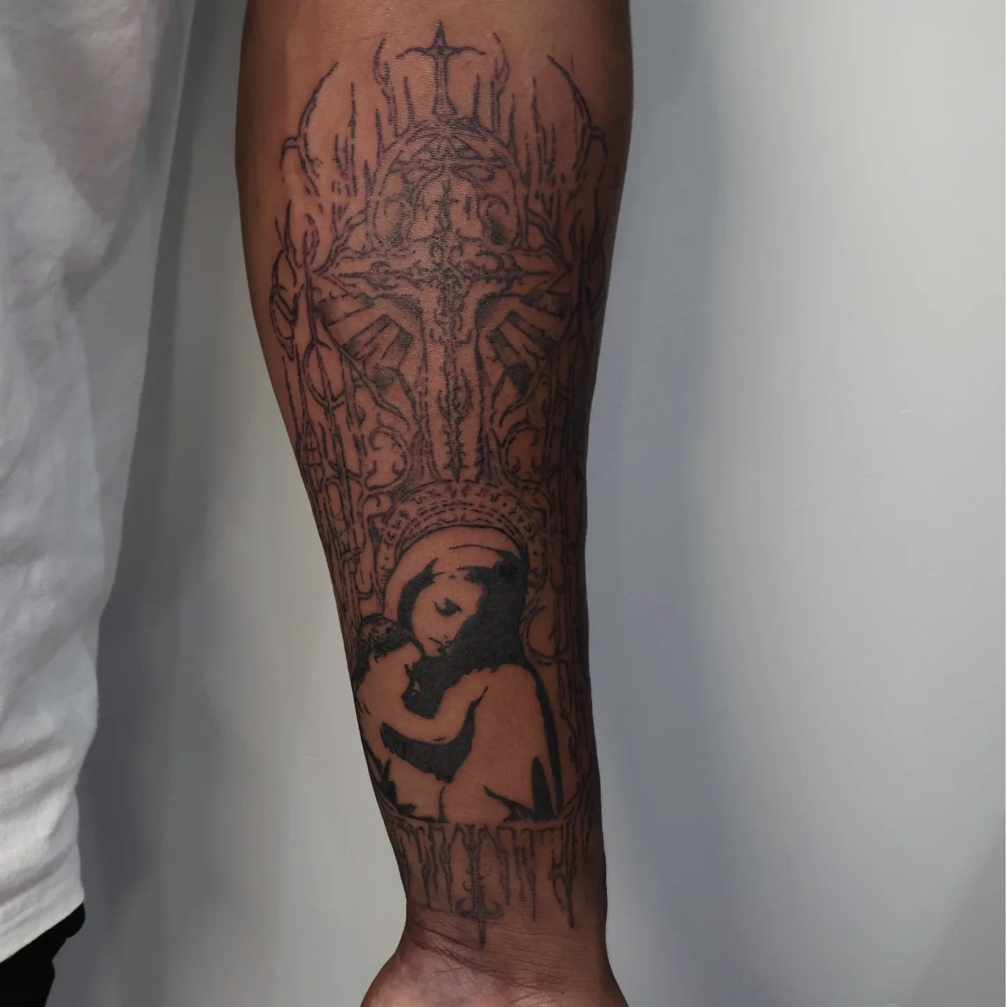 Religious iconography black and grey tattoo on the forearm by Joc