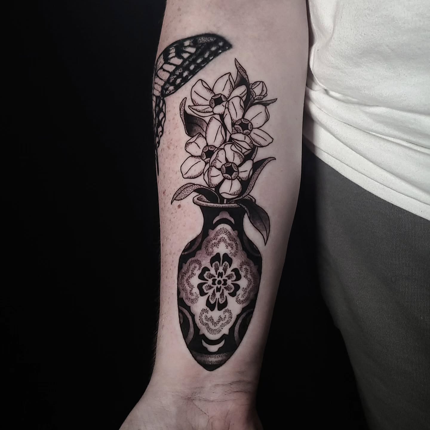 Vase with flowers black and grey tattoo on the forearm by Alex Stairs