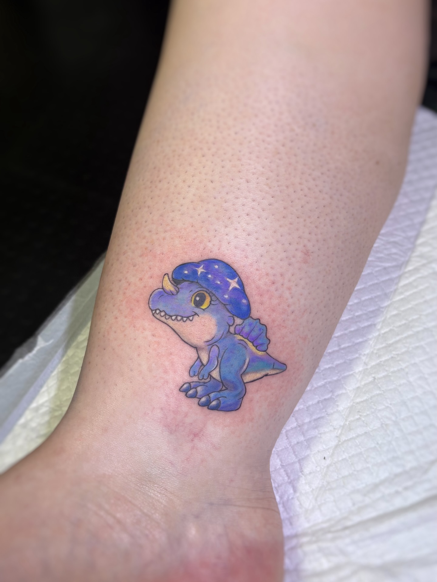 Dinosaur dotwork tattoo on the forearm by Art by Aimee
