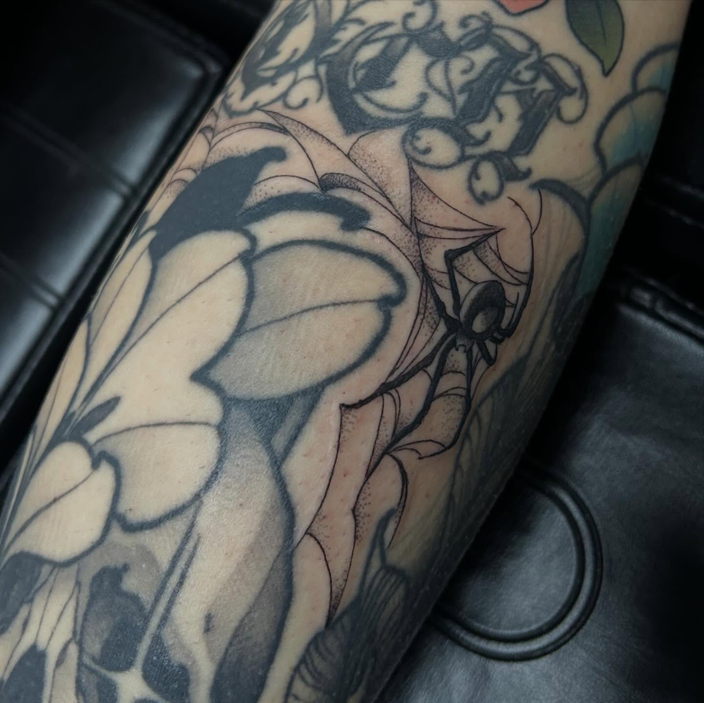 Flower and spider black and grey tattoo on the forearm by 𝕸𝖞𝖆