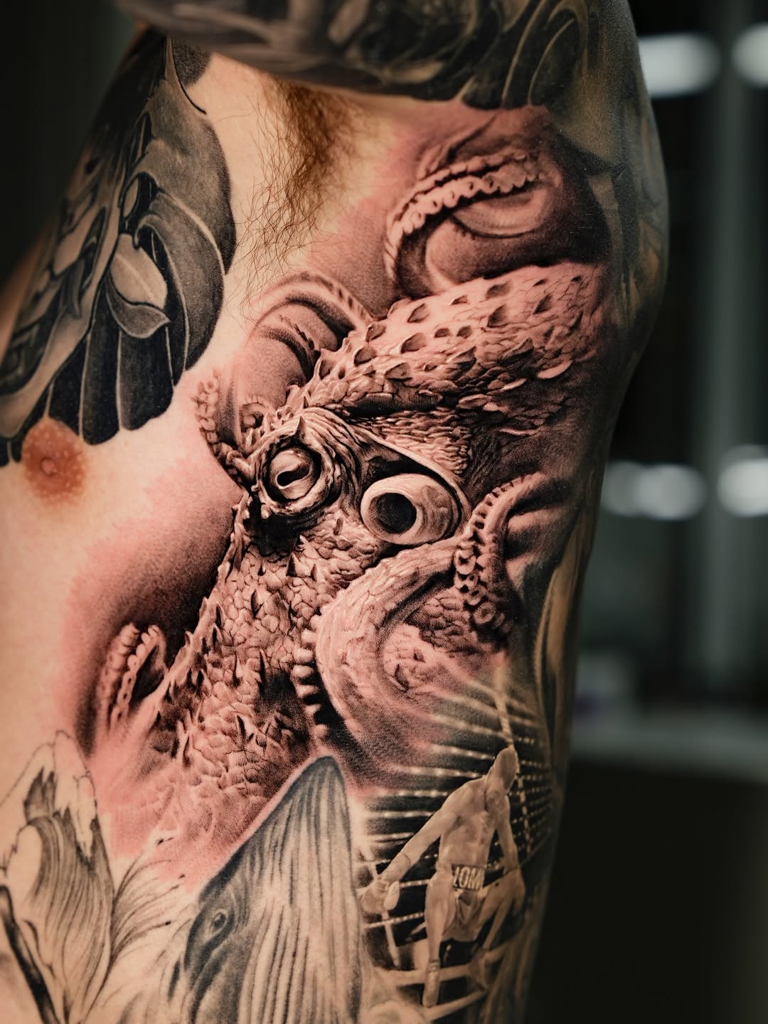 Octopus and boxer realism tattoo on the upper arm by Gody