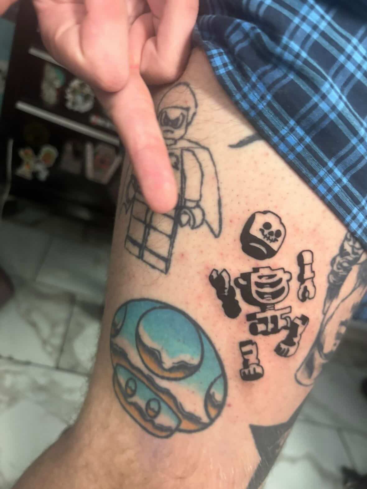 LEGO-themed geometric tattoo on the forearm by linda perez