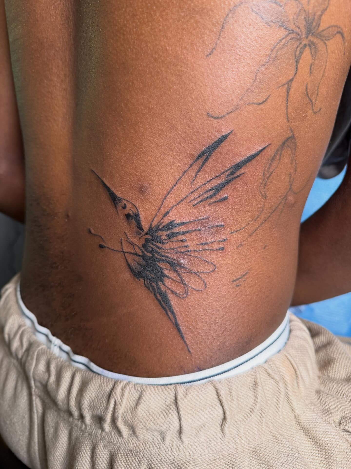 Bird black and grey tattoo on the thigh by linda perez