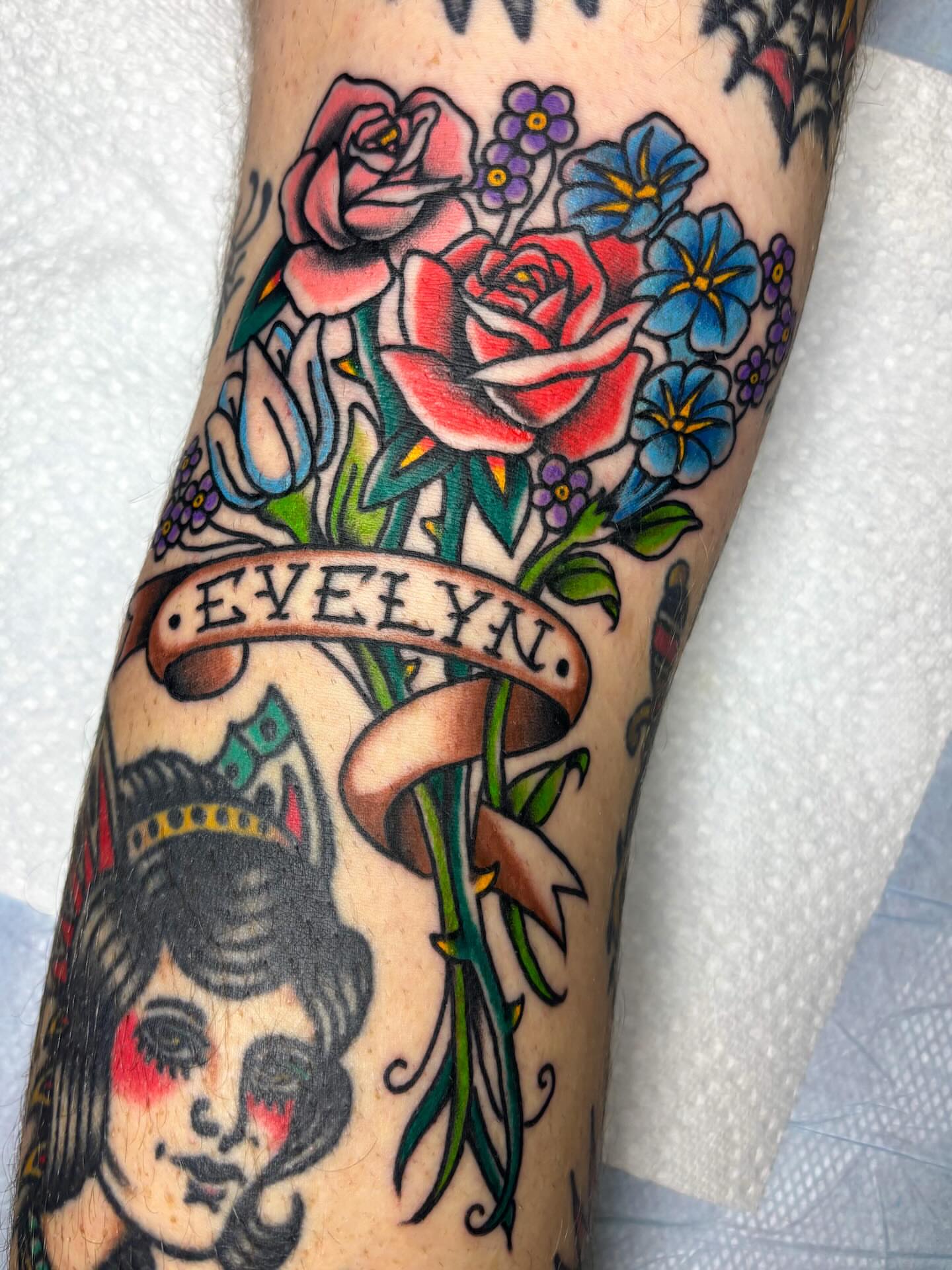 Floral bouquet American traditional tattoo on the forearm by Katelyn Spence