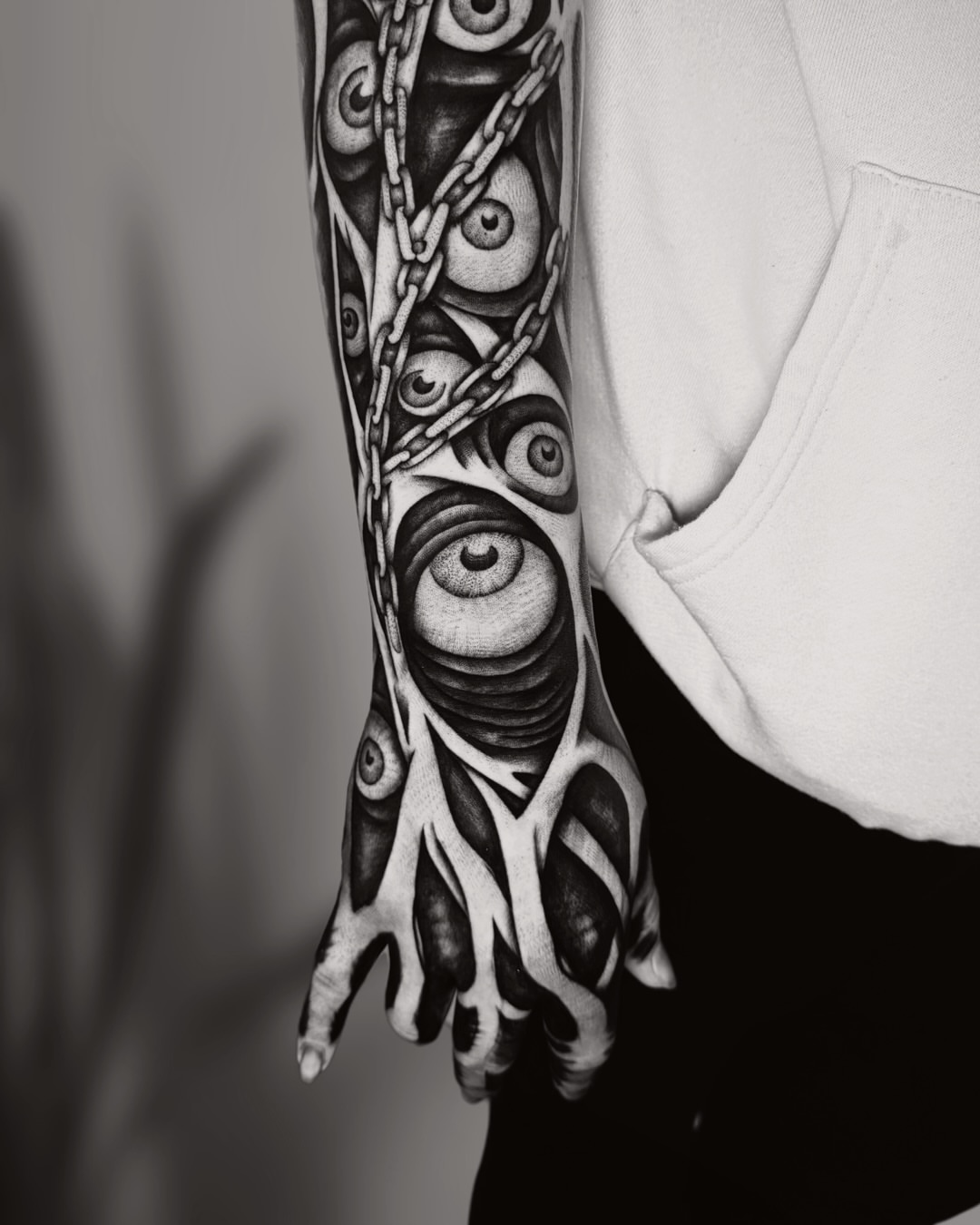 Eyes and chains geometric tattoo on the forearm by Ingrid Rojas
