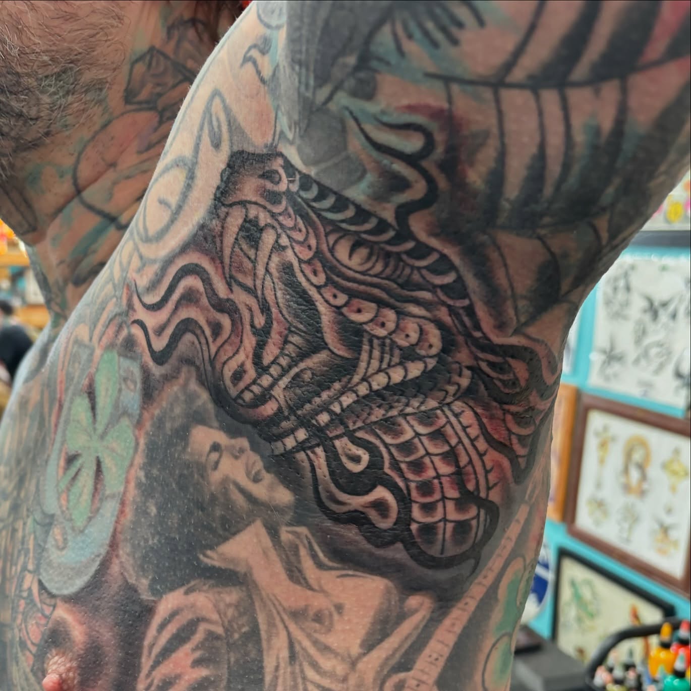 Woman and dragon American traditional tattoo on the upper arm by Cody Wallenius, Merrillville, Indiana