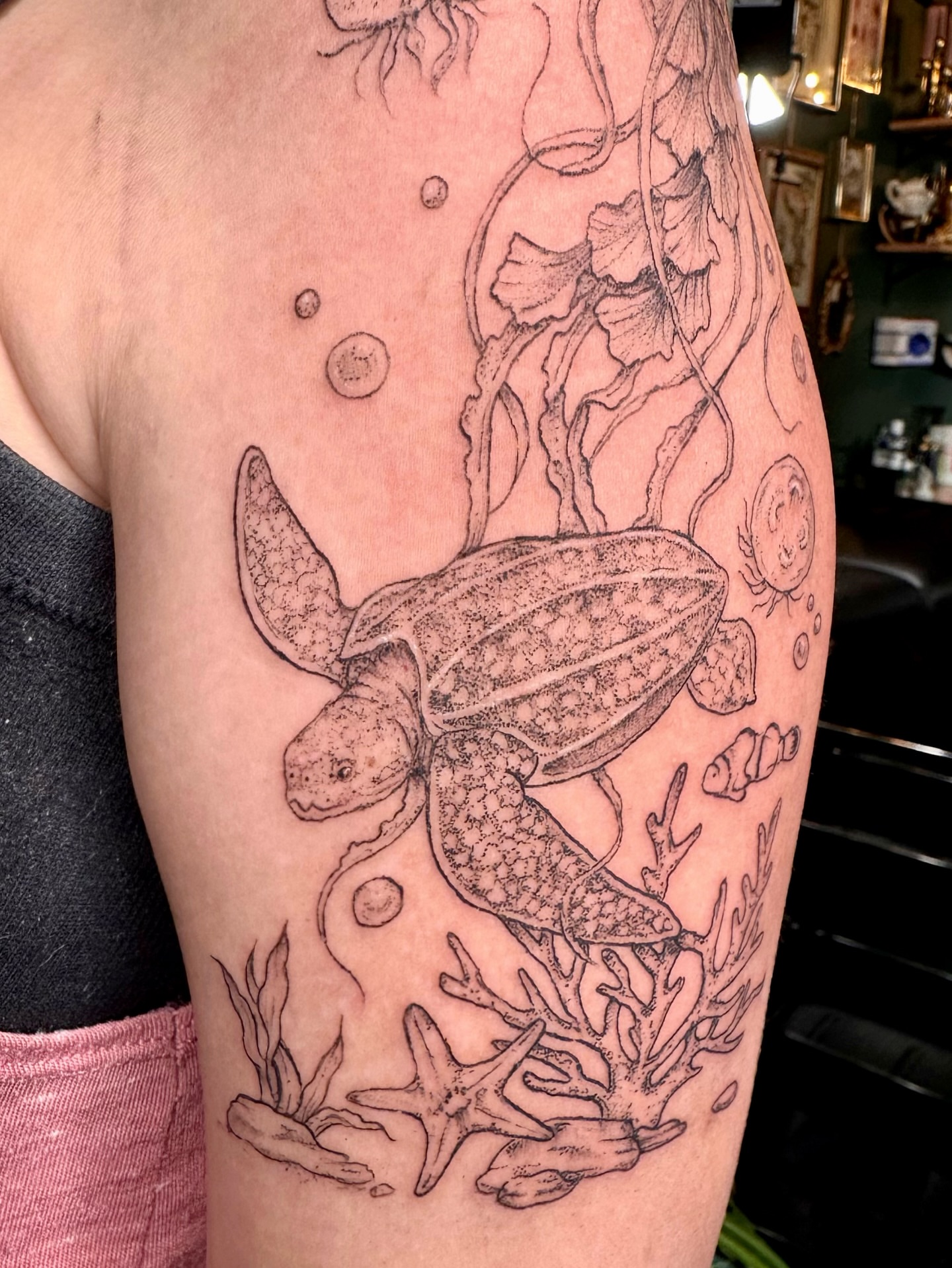Sea turtle dotwork tattoo on the upper arm by kenzie hunter