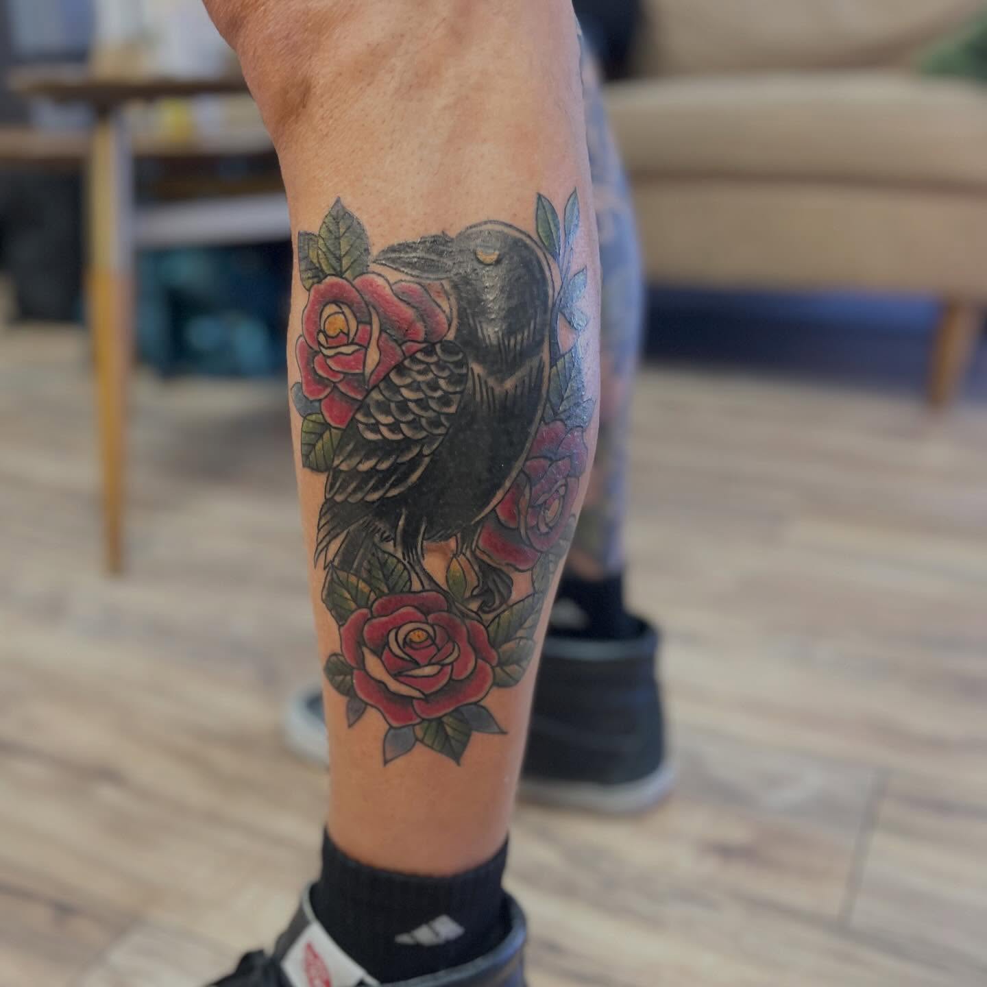 Crow and roses American traditional tattoo on the forearm by Victorian Coleman