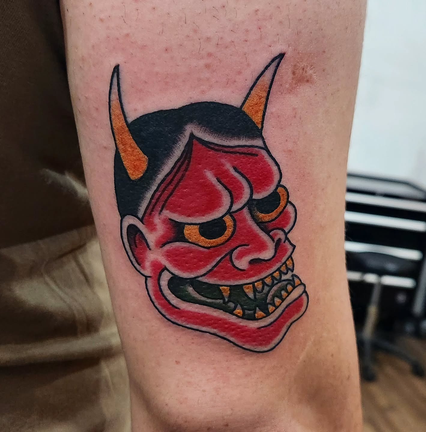 Demon mask American traditional tattoo on the forearm by Douglas Grady