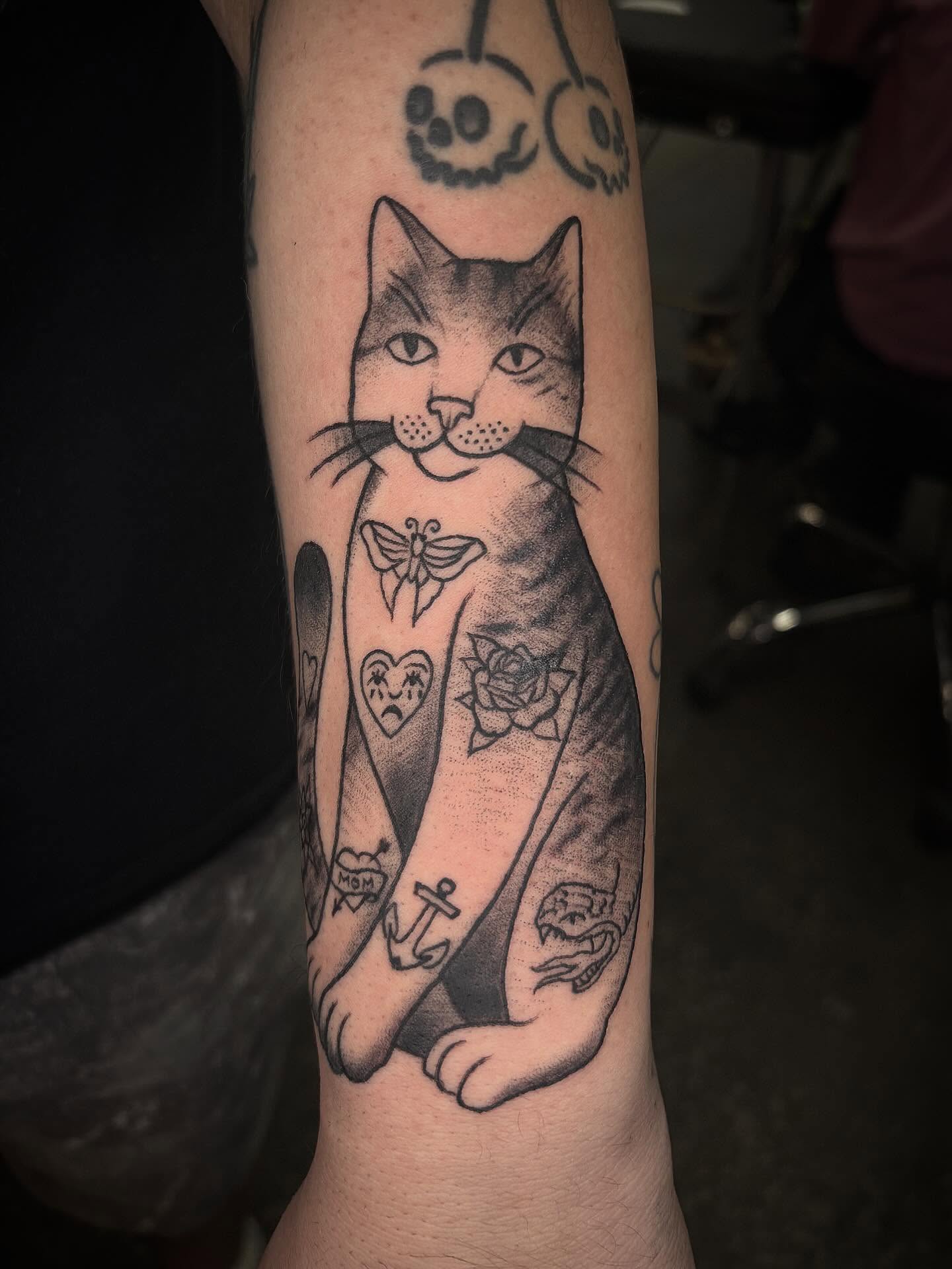 Cat black and grey tattoo on the forearm by Brett Ferguson