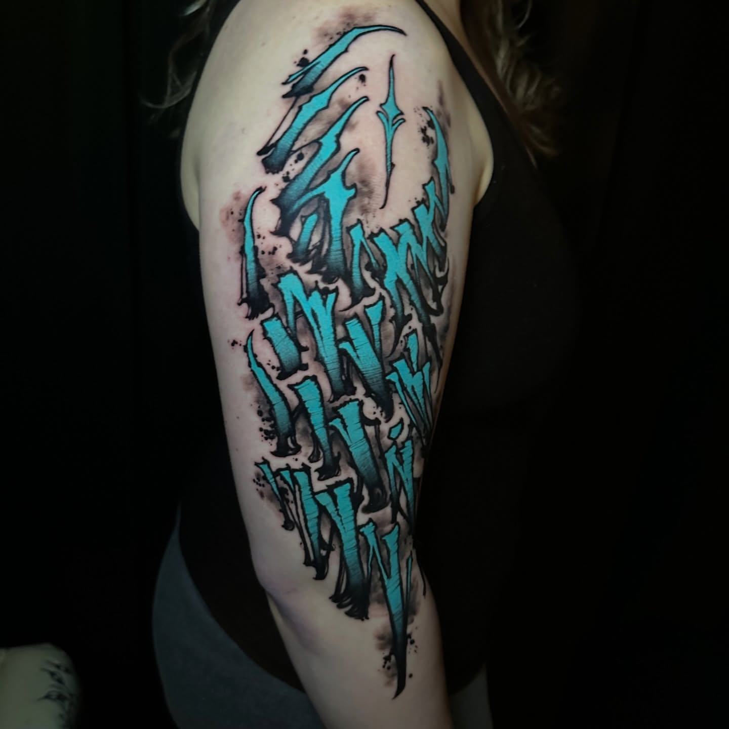 Abstract lettering dotwork tattoo on the shoulder by Skylar Mangrum