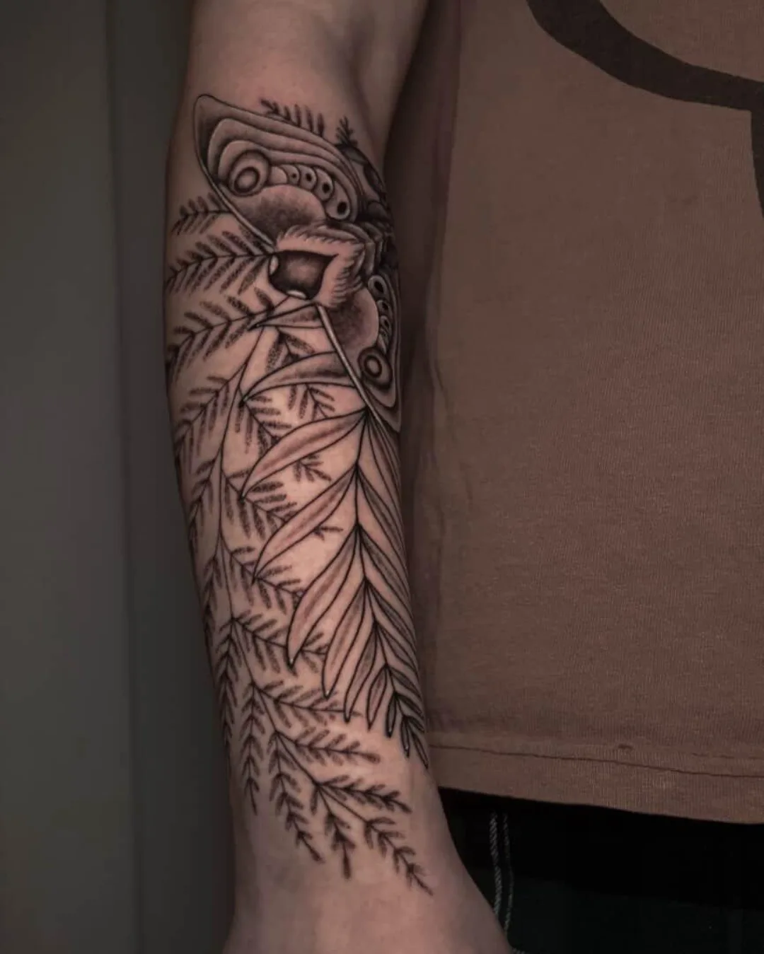 Feathered bird black and grey tattoo on the forearm by Sal