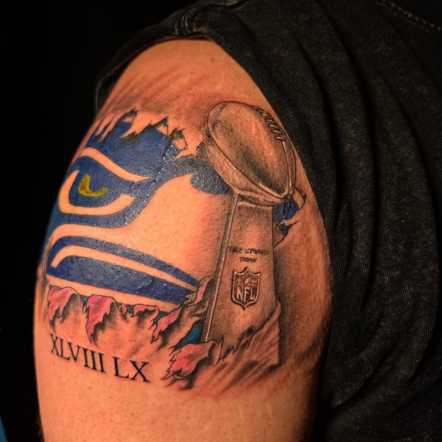 Seahawks logo and Lombardi Trophy realism tattoo on the shoulder by "Gentle"Jay Blondel