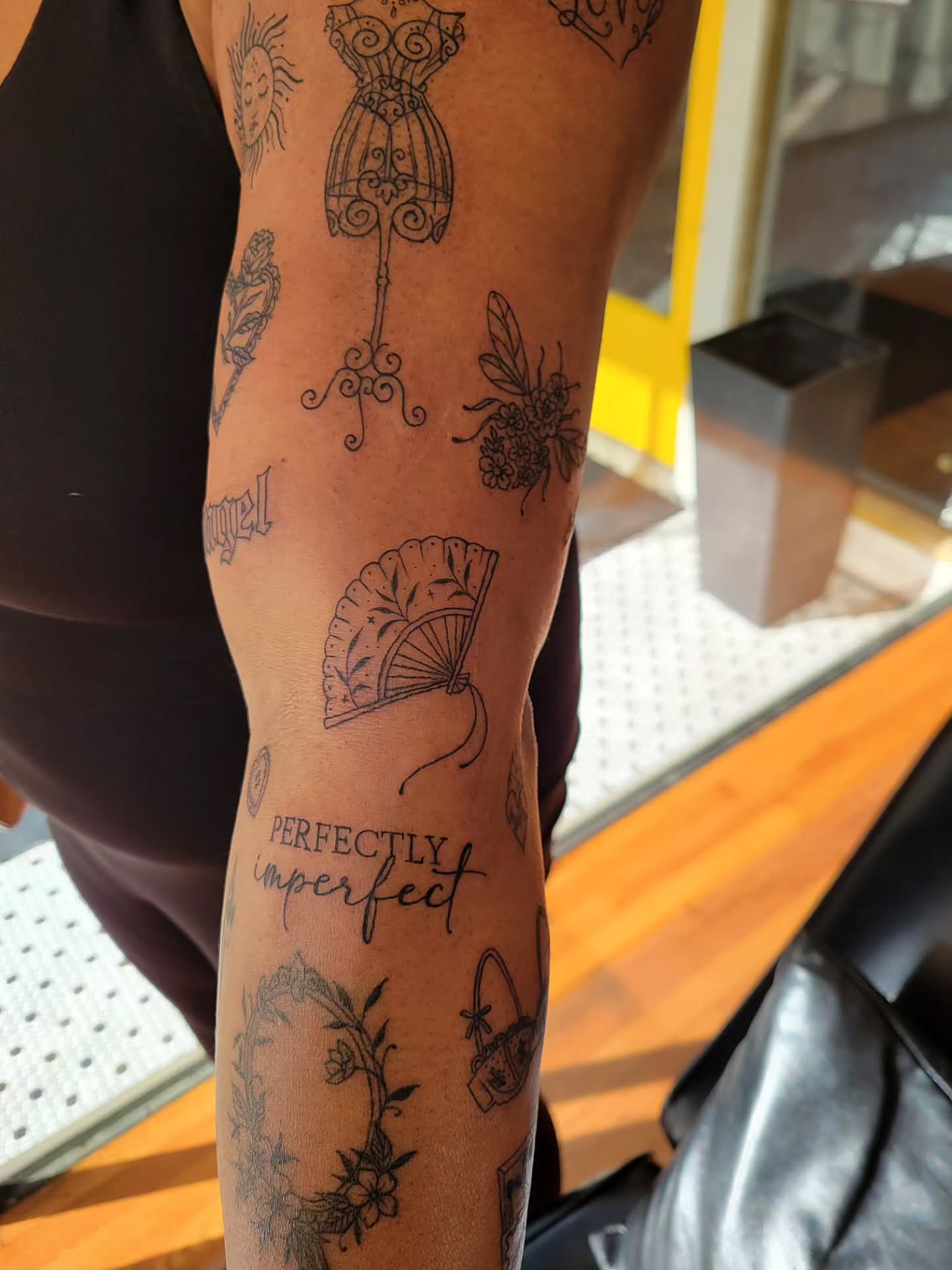 Fan and floral black and grey tattoo on the forearm by Solstice Tattoos by Savannah Sadler (future, Salisbury, North Carolina