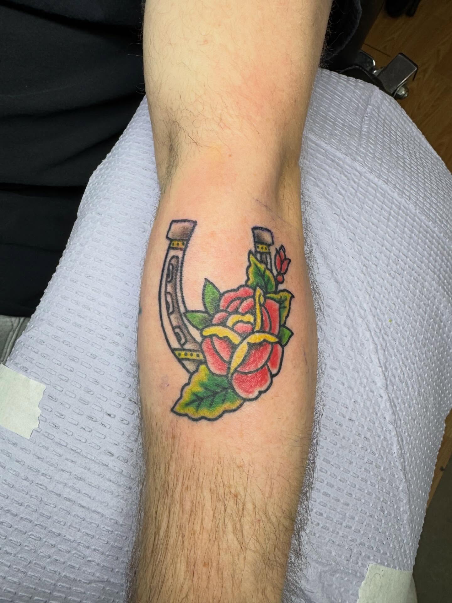 Horseshoe and rose American traditional tattoo on the forearm by Justin Fiveson
