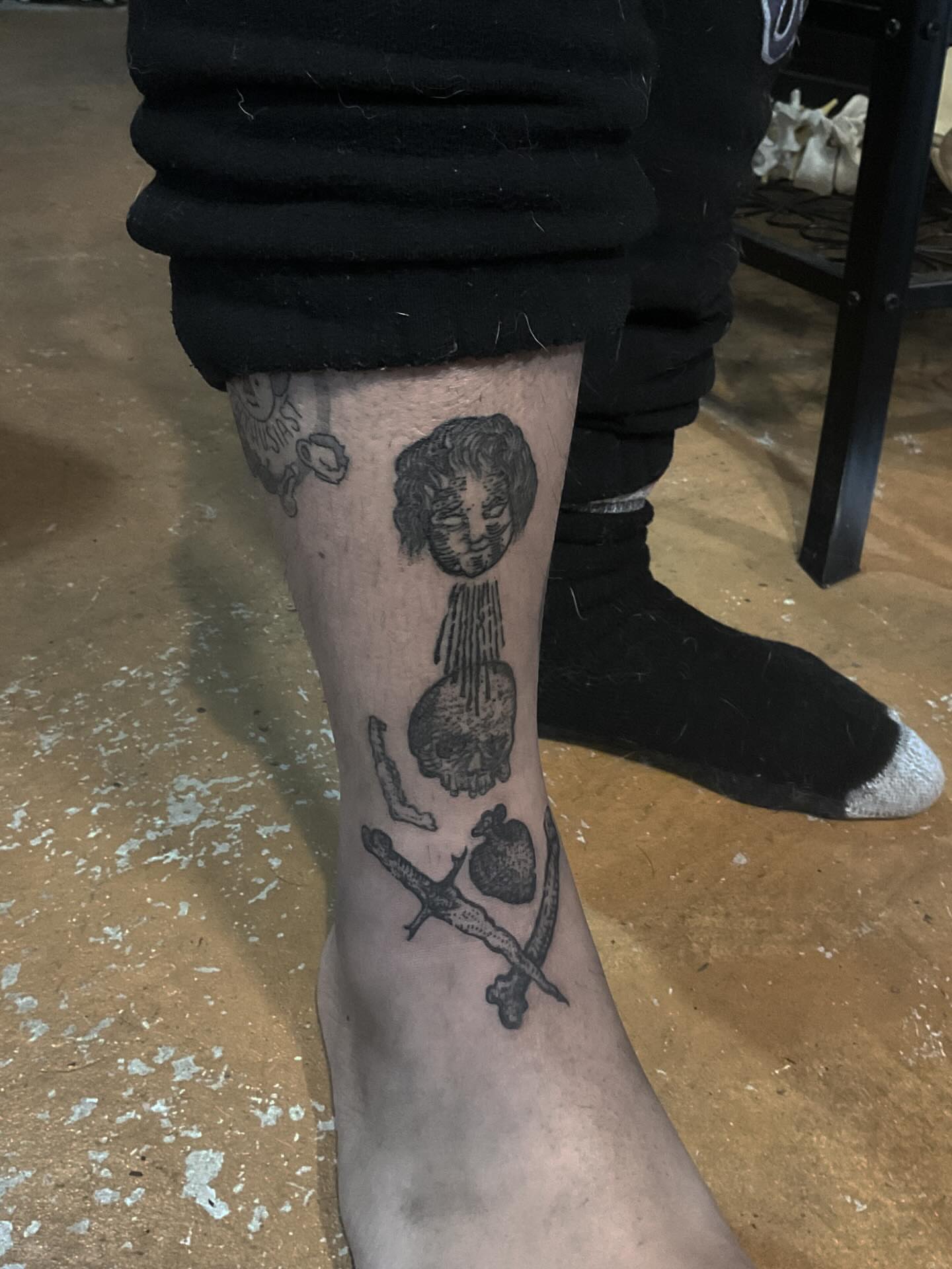 Skull and dripping face black and grey tattoo on the calf by ๐ญ๐๐๐๐