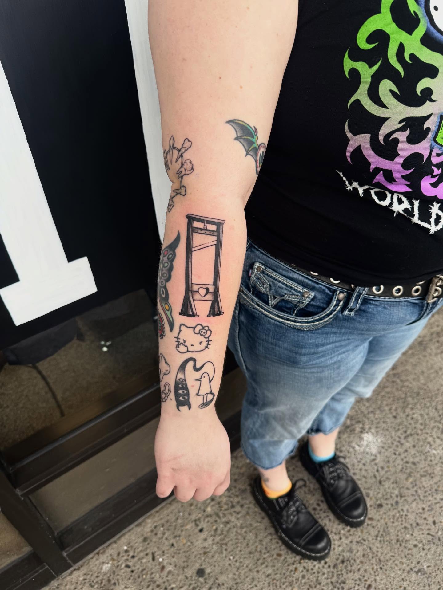 Hello Kitty American traditional tattoo on the forearm by Ren Miljus