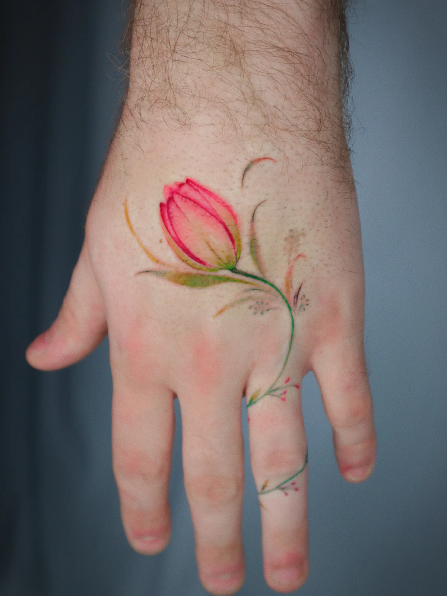 Flower watercolor tattoo on the hand by River