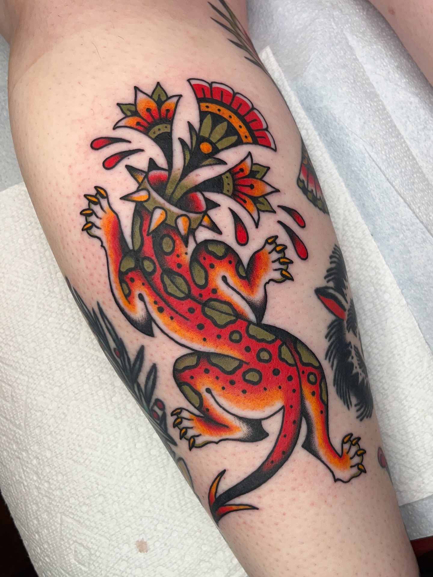 Gecko and flowers American traditional tattoo on the forearm by Nat Power