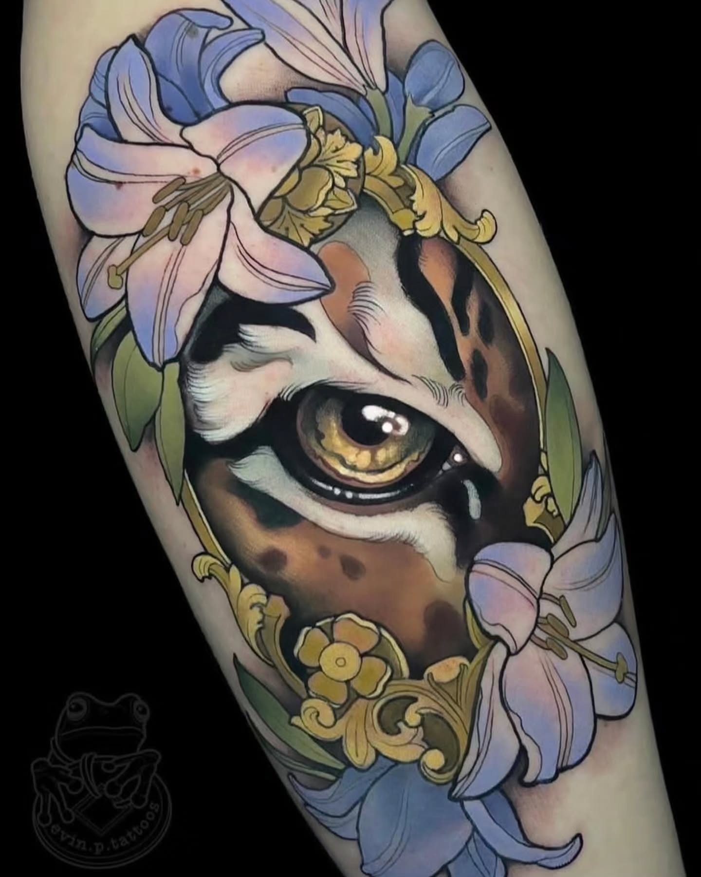 Tiger eye with flowers realism tattoo on the forearm by Evin Pfaff, Bedford, Pennsylvania
