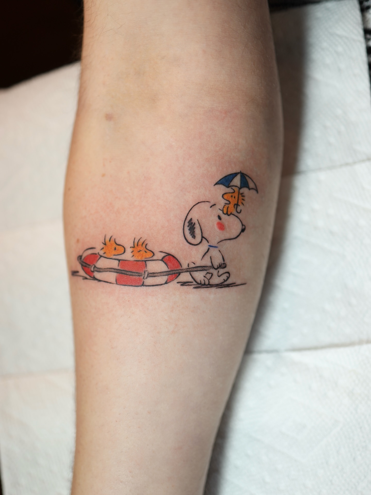 Snoopy and friends illustrative tattoo on the forearm by morgan purcey