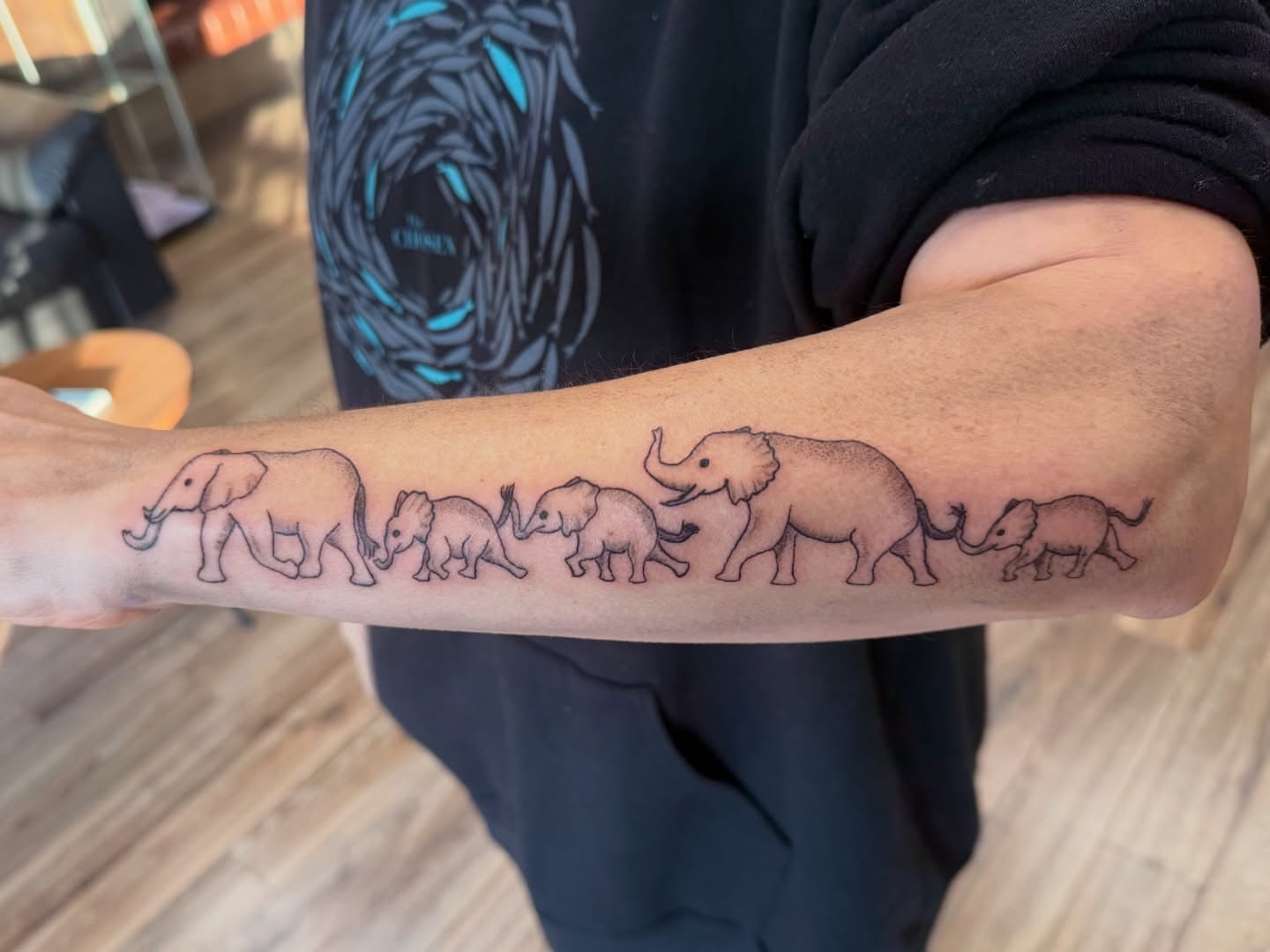 Elephant family black and grey tattoo on the forearm by Giana Masso