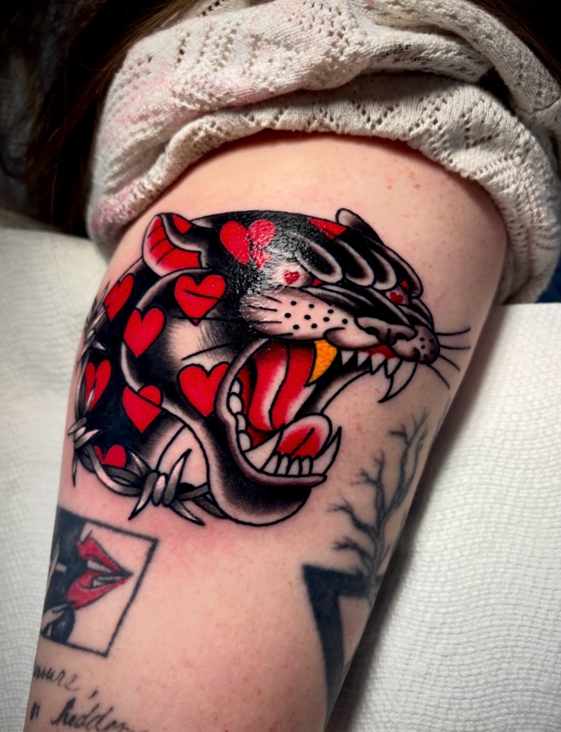 Panther with hearts American traditional tattoo on the shoulder by Mickey Putillo, Charlotte, North Carolina