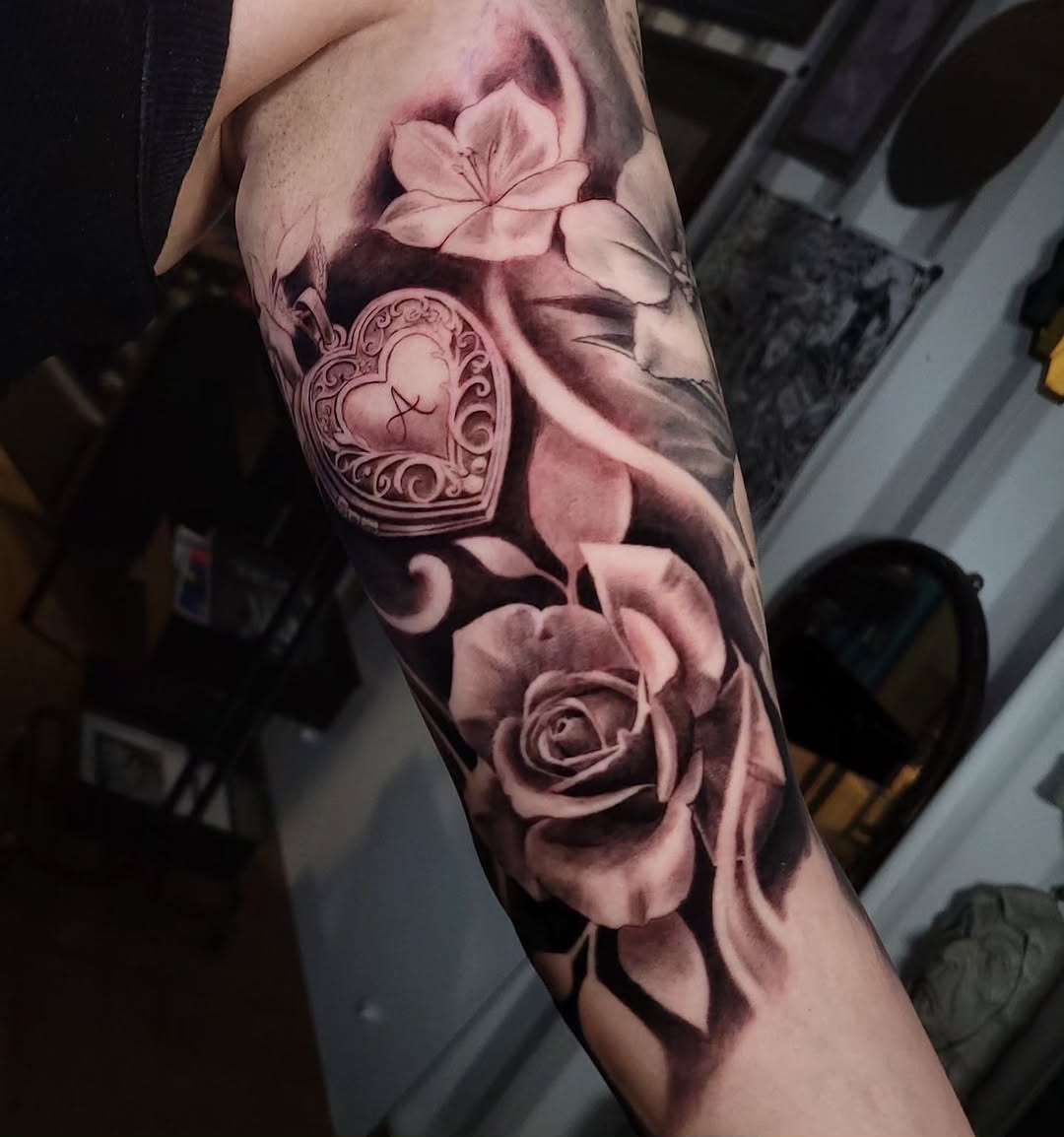 Heart locket and rose Chicano tattoo on the forearm by Brandon Rabago, Fort Worth, Texas