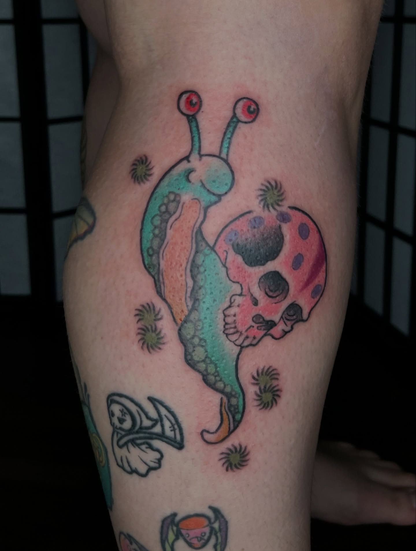 Snail and skull new school tattoo on the thigh by Vic Merkley
