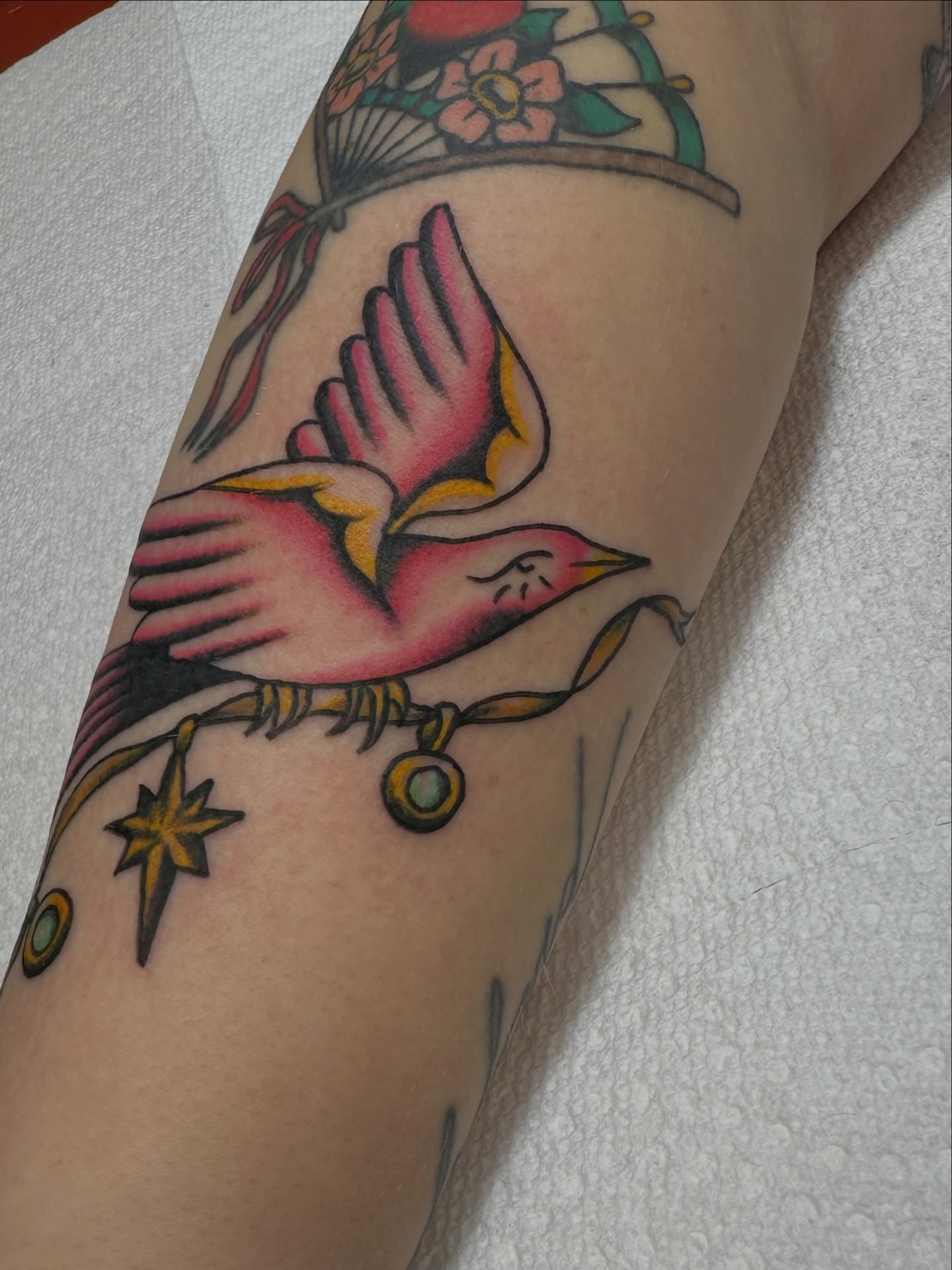 Bird American traditional tattoo on the forearm by Hannah Eddy