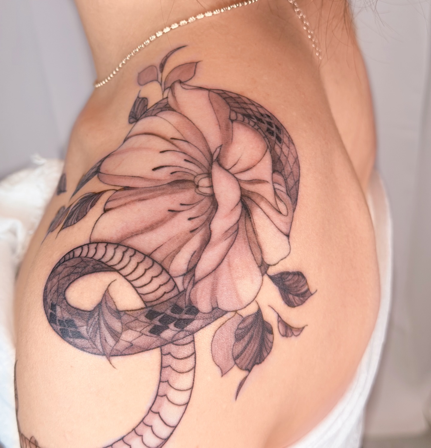 Snake and peony realism tattoo on the thigh by Charlotte