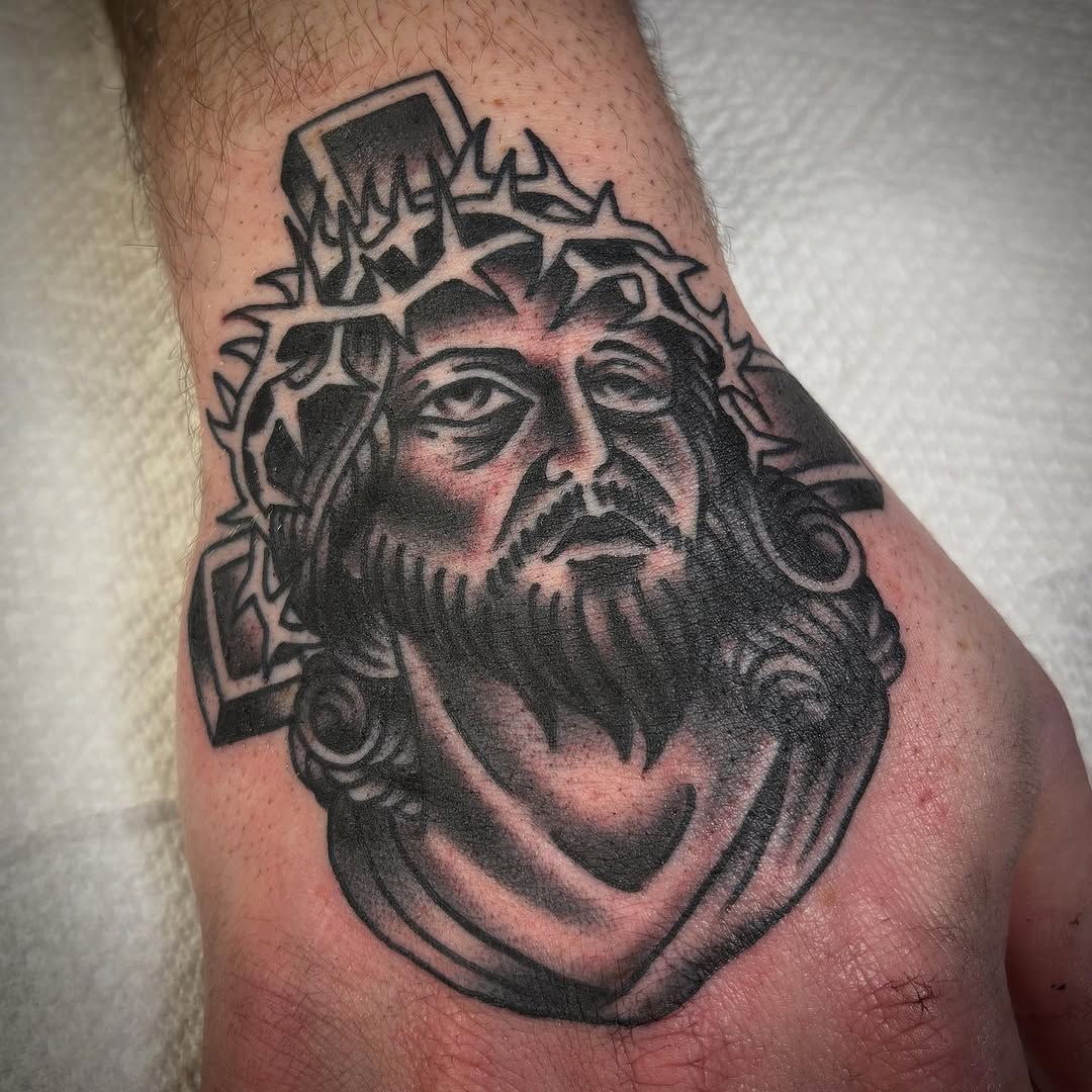 Jesus Christ with crown of thorns realism tattoo on the forearm by Tom Wenzell