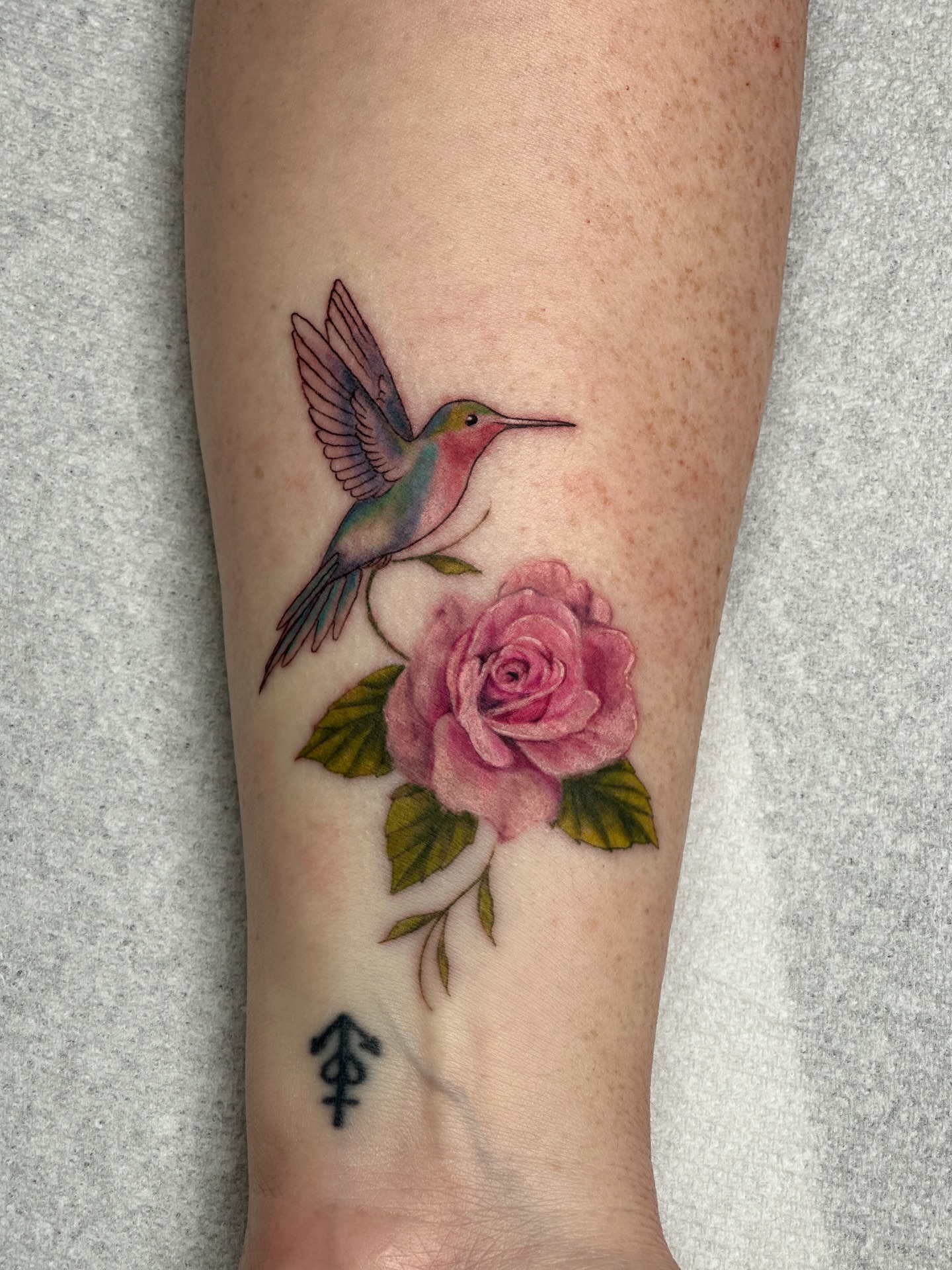 Hummingbird and rose realism tattoo on the forearm by Nashville Tattoo Artist - Nicolette Madlyne