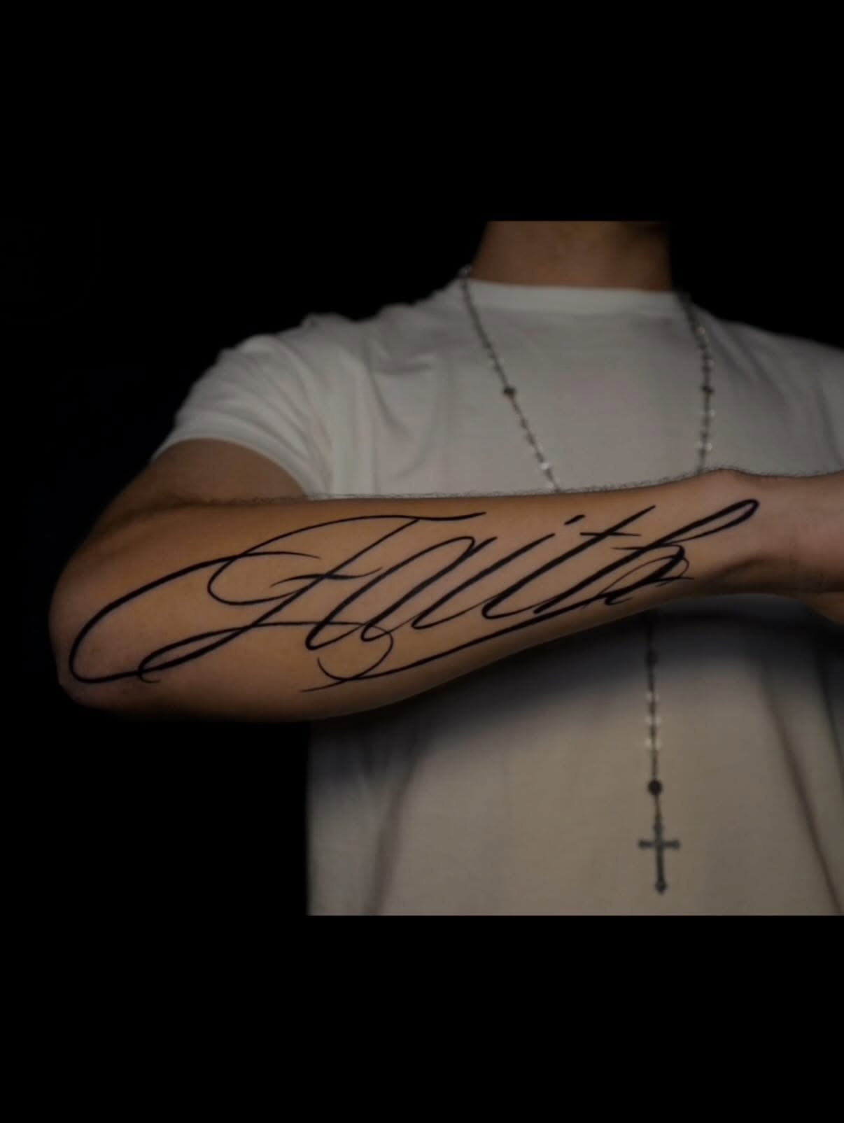 Faith lettering script tattoo on the forearm by Tattoo Artist