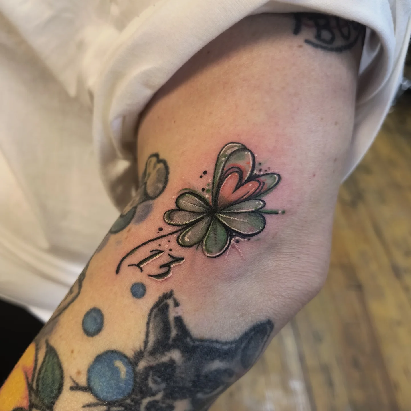 Four-leaf clover dotwork tattoo on the forearm by Niki Jackson