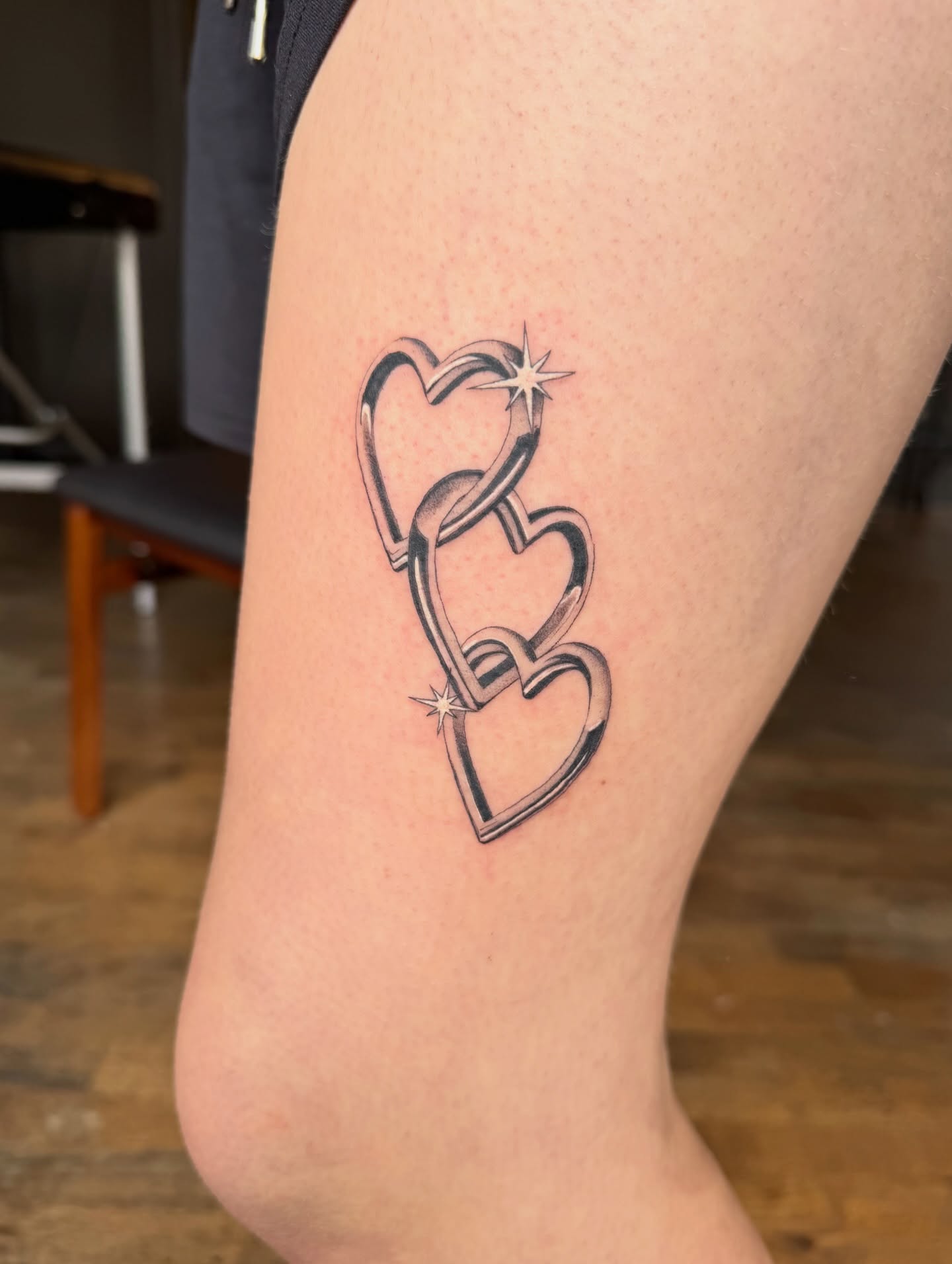Interlocking hearts black and grey tattoo on the thigh by Lily Cuoio~ Seattle