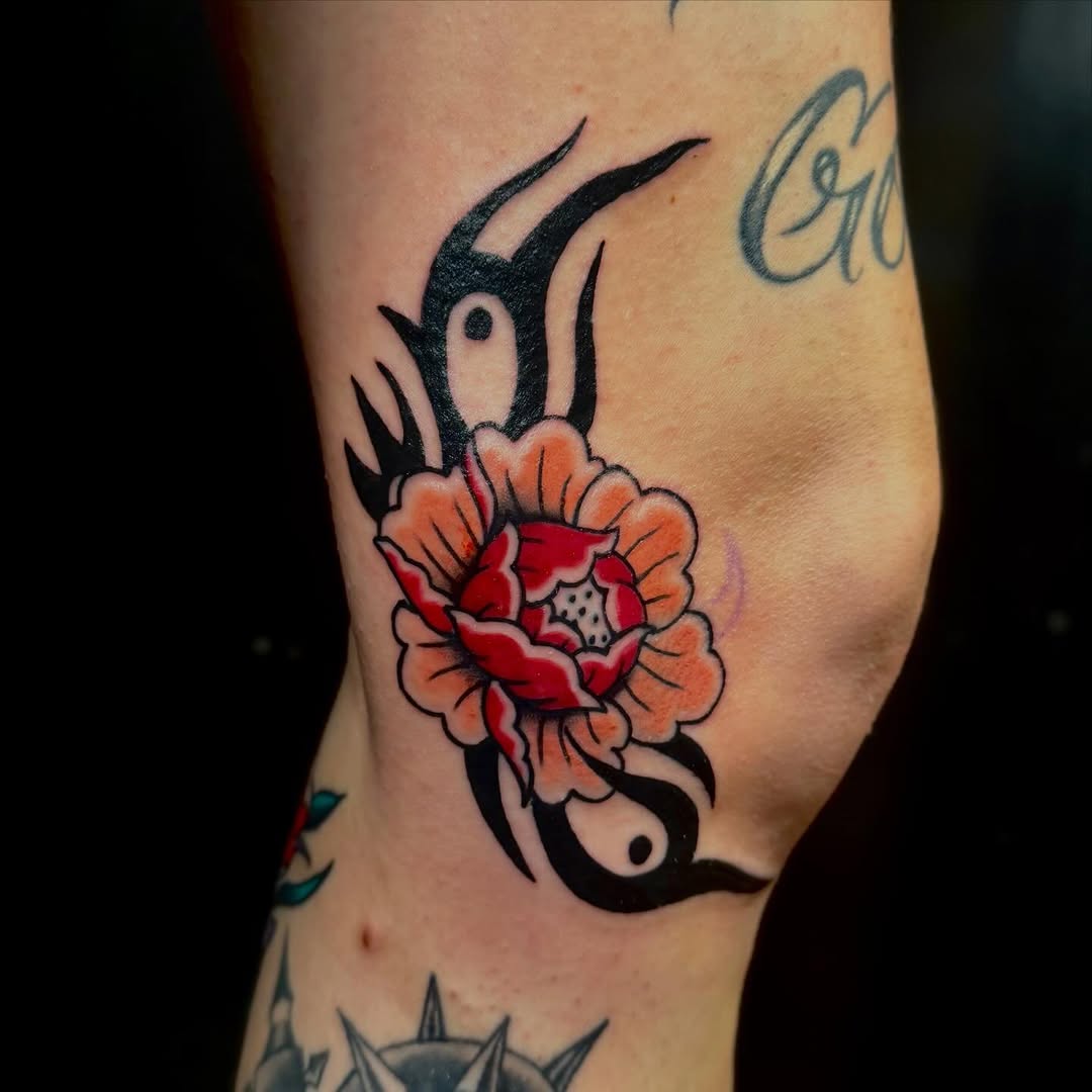 Flower with tribal elements neo-traditional tattoo on the forearm by savannah
