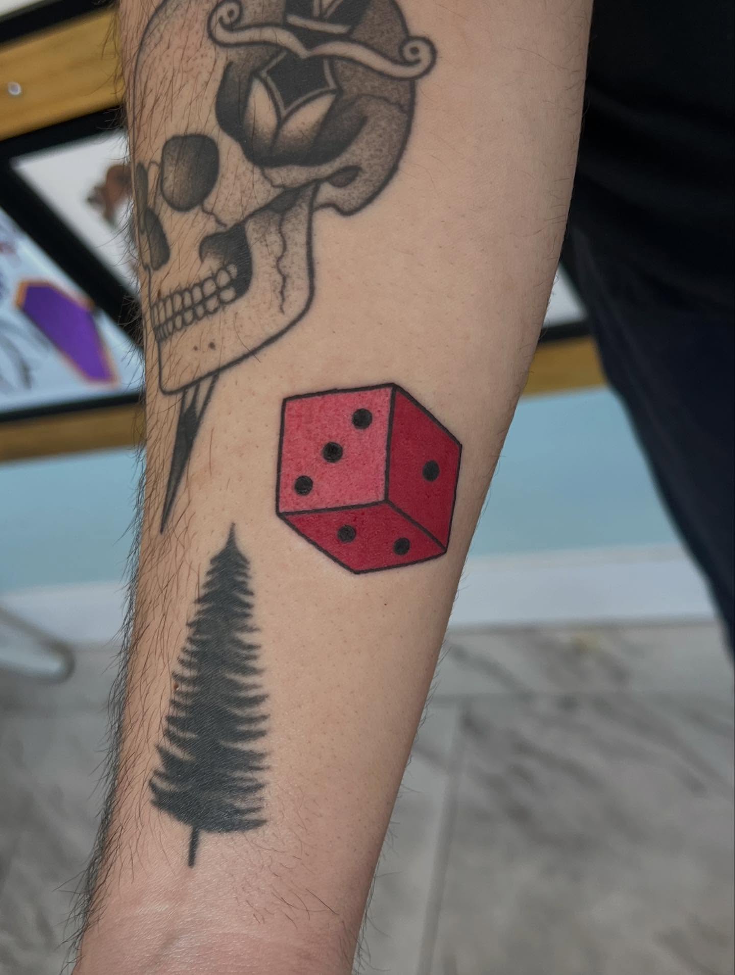 Red dice American traditional tattoo on the forearm by 𝖆𝖑𝖞𝖘𝖘𝖆 ☽