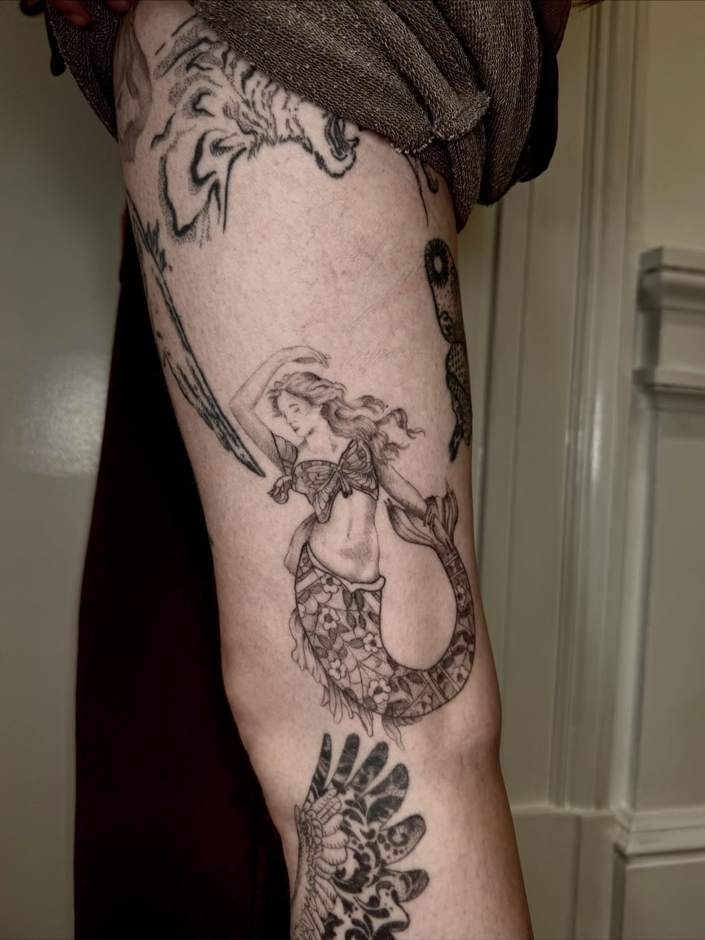 Mermaid black and grey tattoo on the forearm by Ian Saner