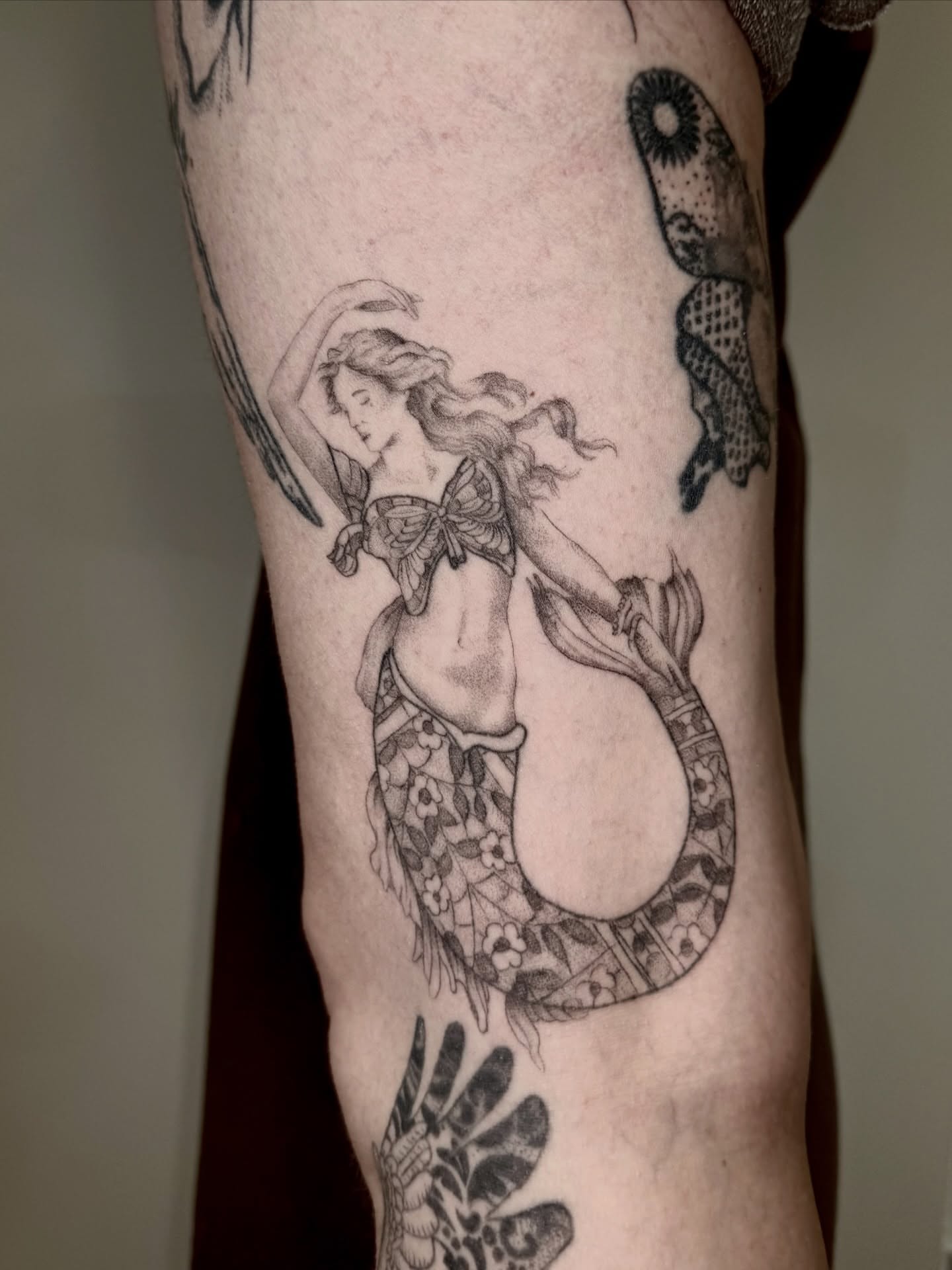 Mermaid black and grey tattoo on the forearm by Ian Saner