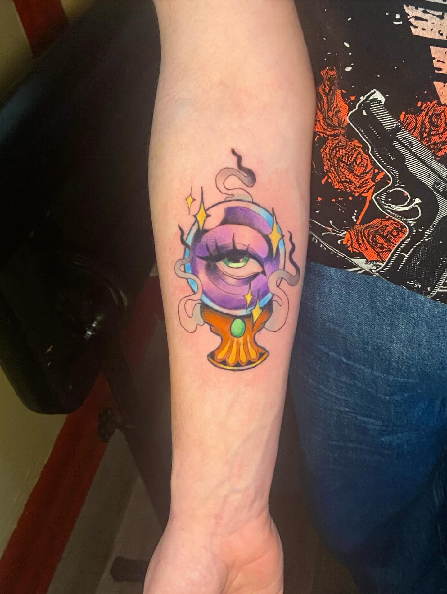 Eye in crystal ball new school tattoo on the forearm by 🐆Cam Feral Tattoos