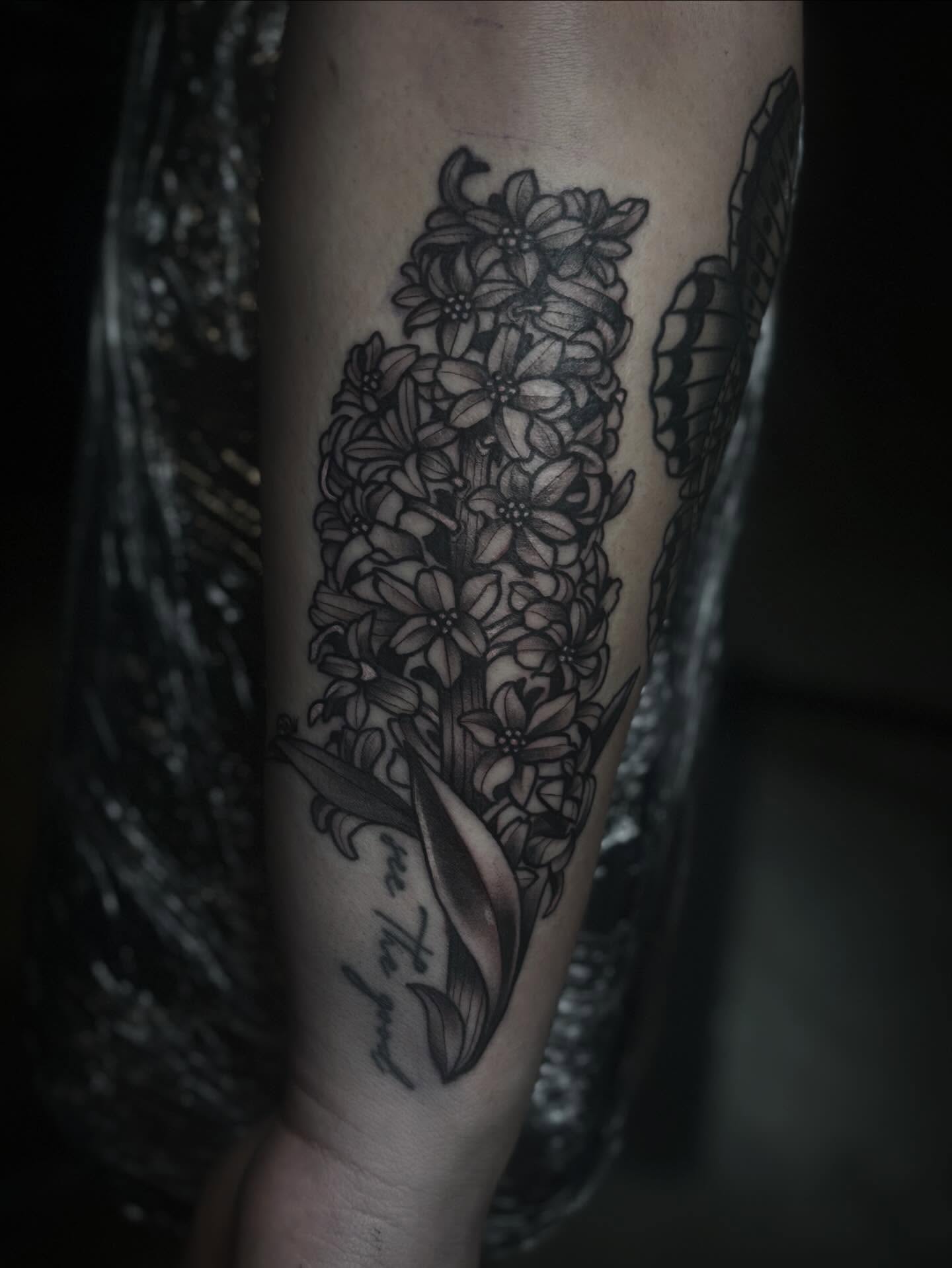 Hyacinths black and grey tattoo on the forearm by Mim
