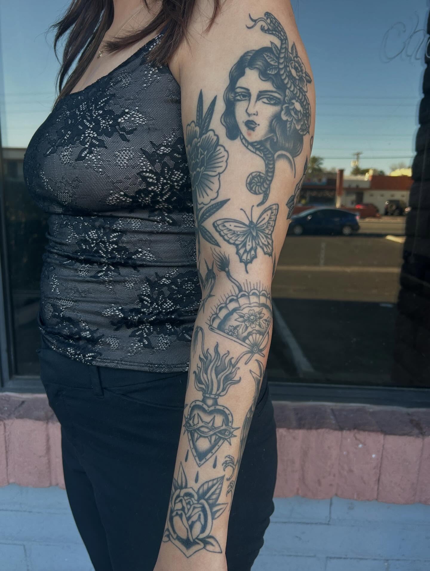 Woman with flowers and butterflies American traditional tattoo on the forearm by Janelle McCarthy