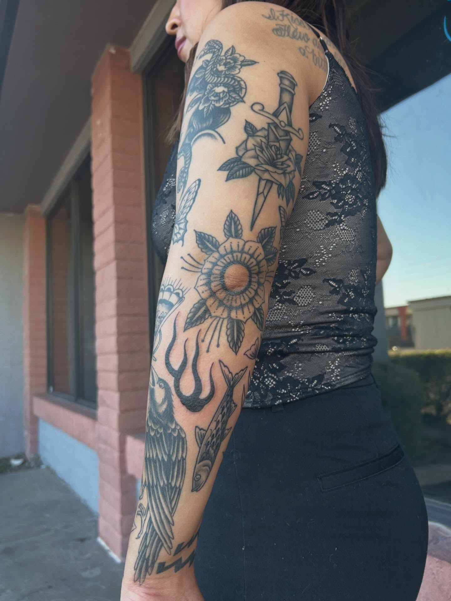 Floral and dagger American traditional tattoo on the forearm by Janelle McCarthy