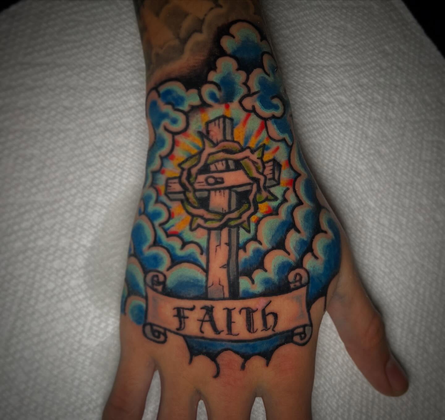 Cross with wreath American traditional tattoo on the hand by James Richardson