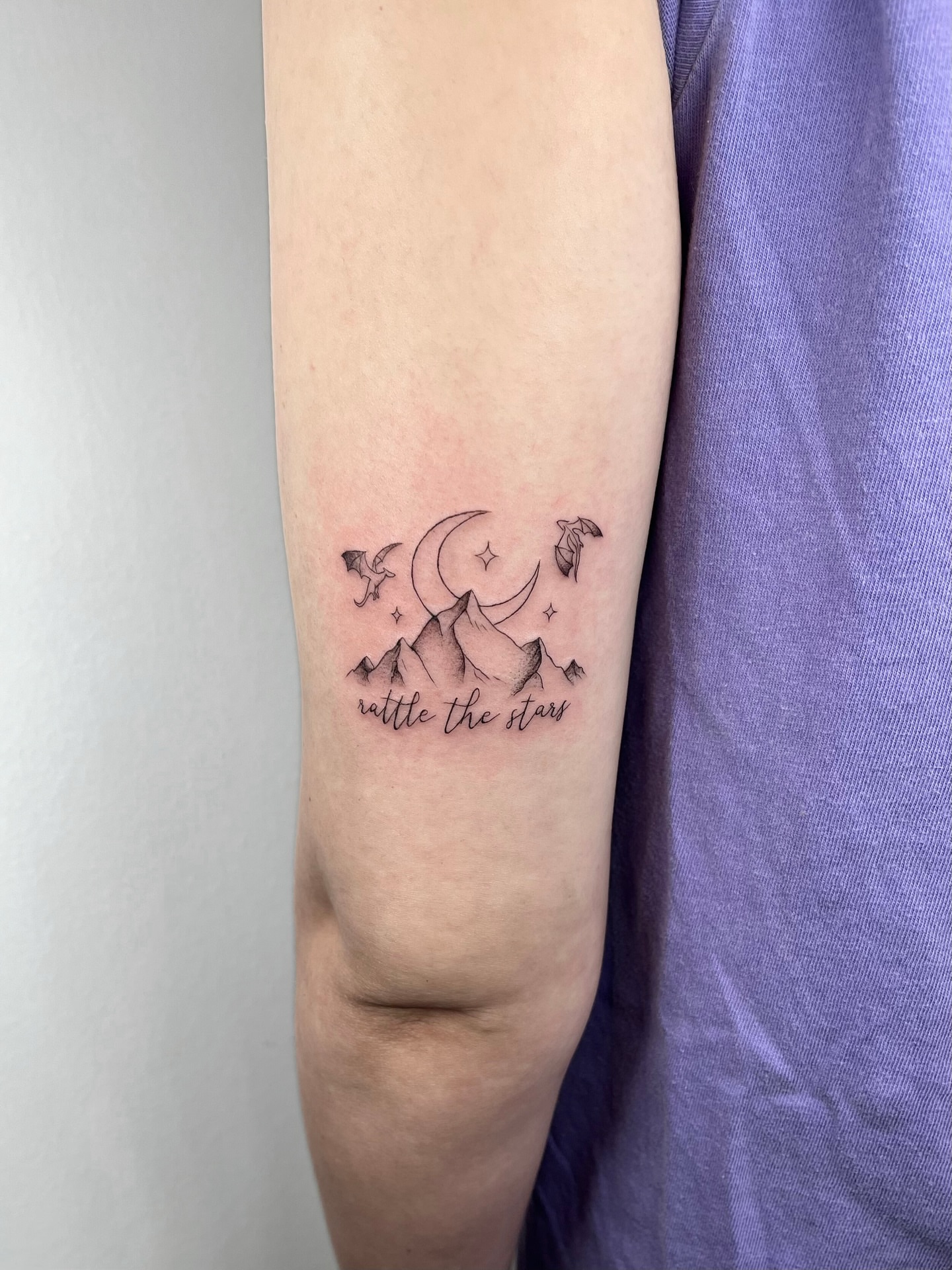 Mountains, moon, stars, birds fine line tattoo on the forearm by kt