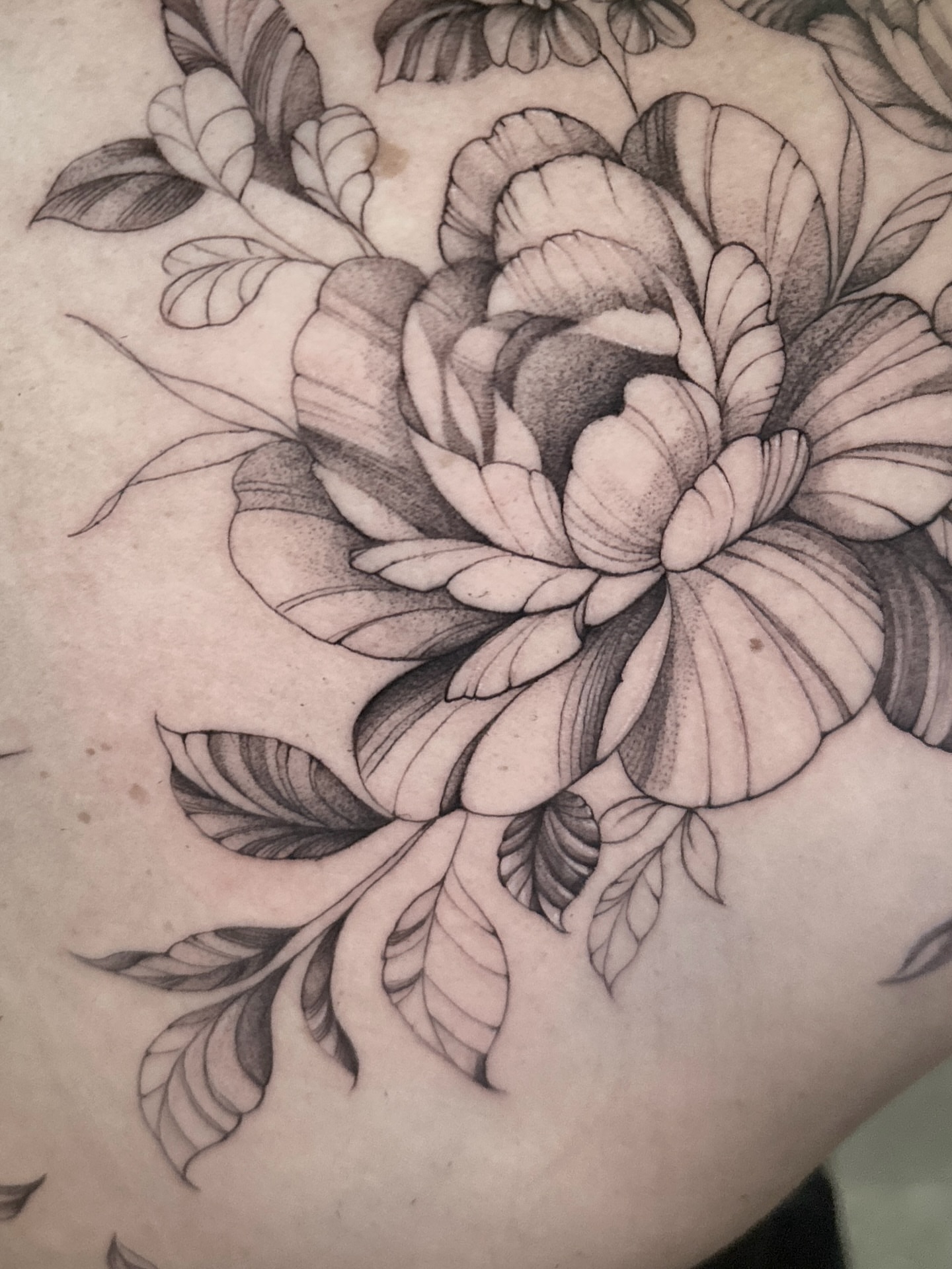 Peony black and grey tattoo on the upper arm by Arhem Quiambao