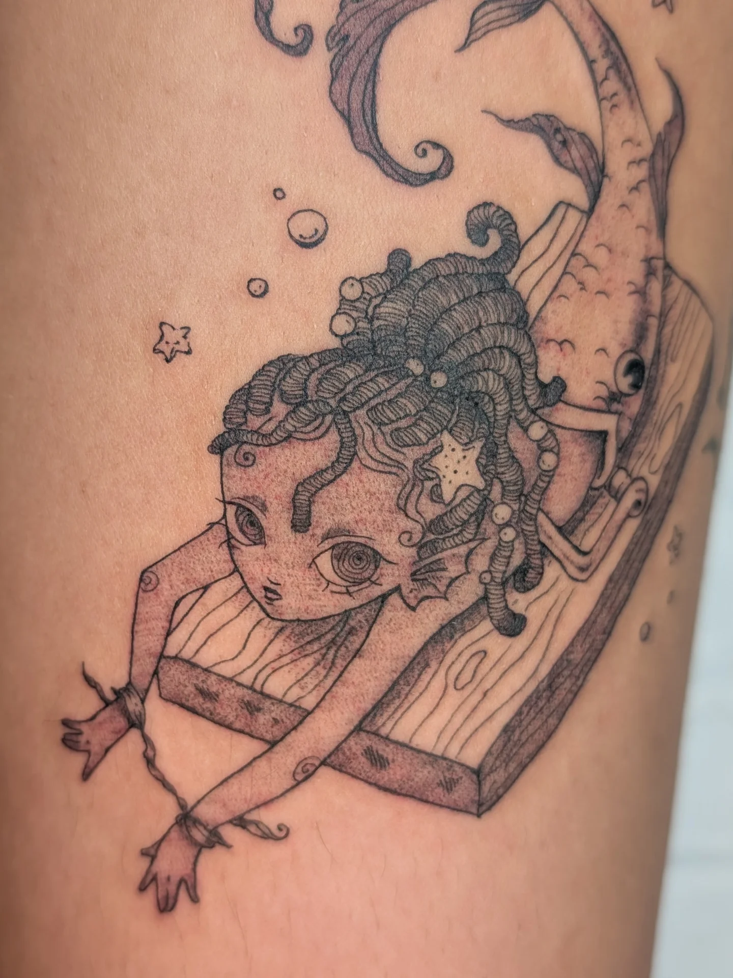 Child with tentacles surrealism tattoo on the thigh by mila