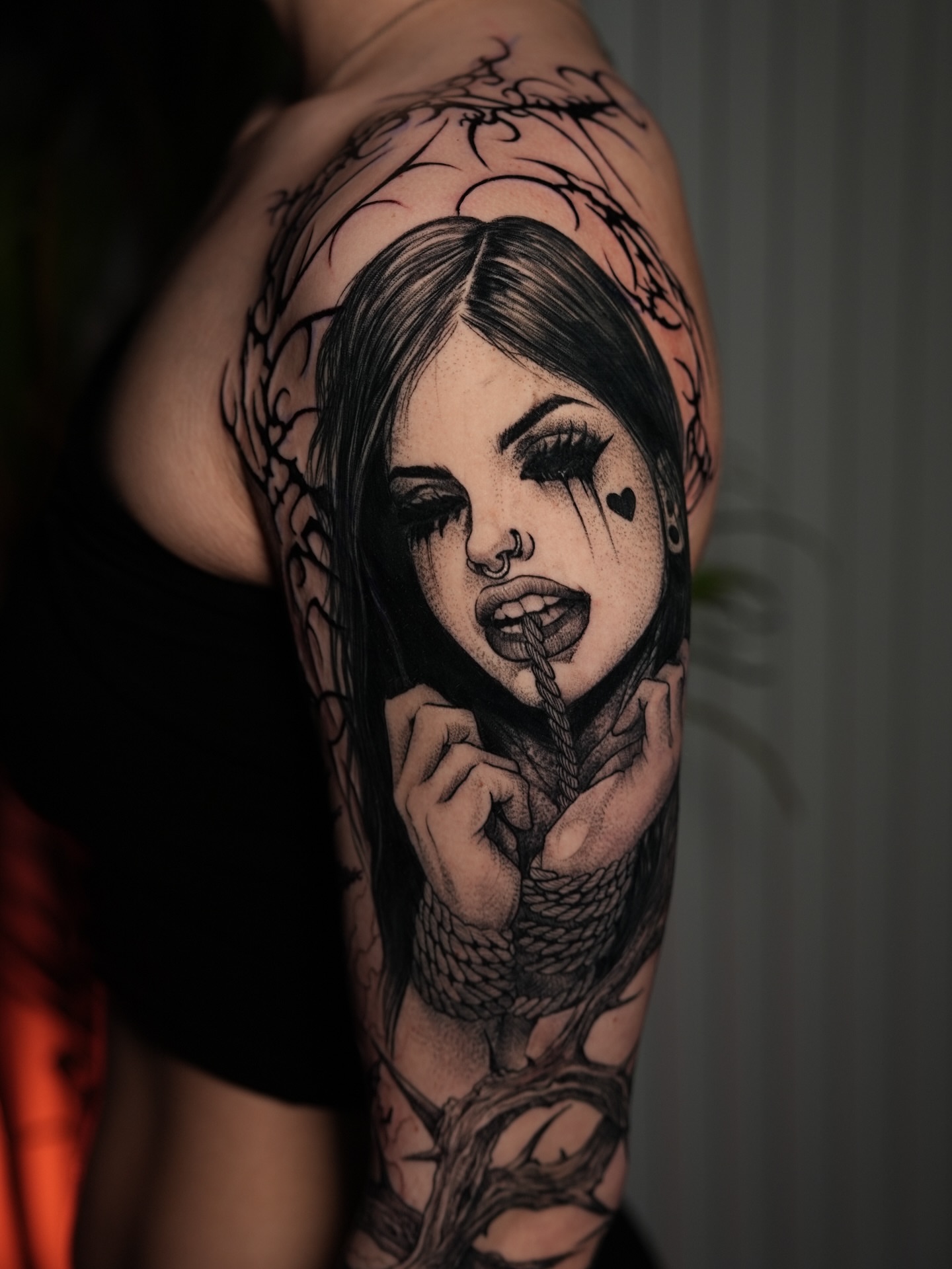 Woman with snake dark realism tattoo on the shoulder by Adrian Gonzalez
